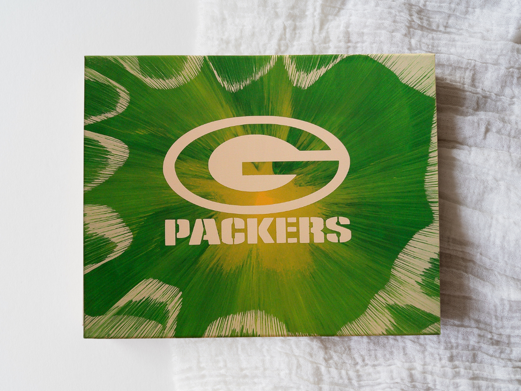 Spin art of Green Bay Packers logo on a custom canvas with a textured background