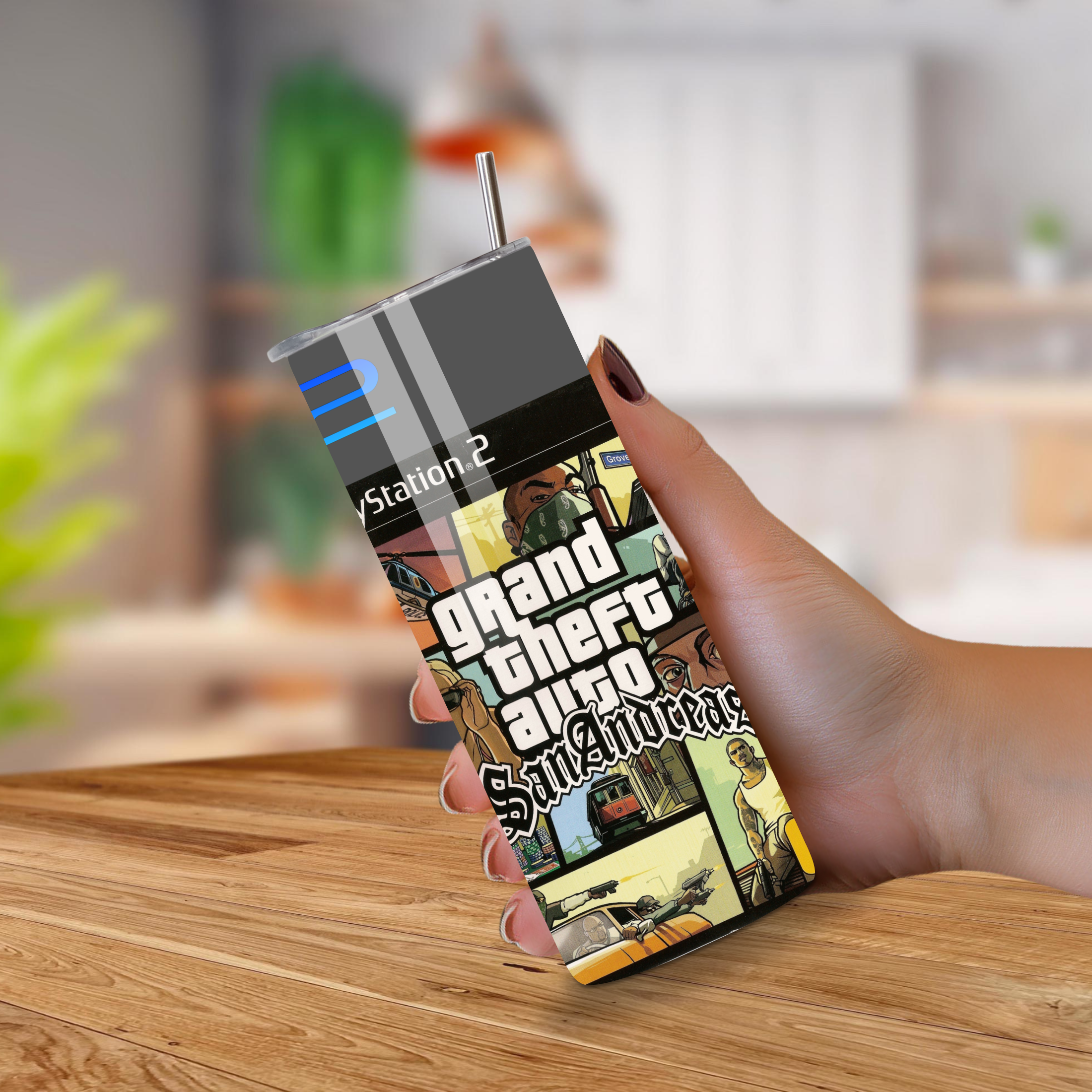Person holding a 20oz tumbler with 'Grand Theft Auto San Andreas' design on a wooden surface.