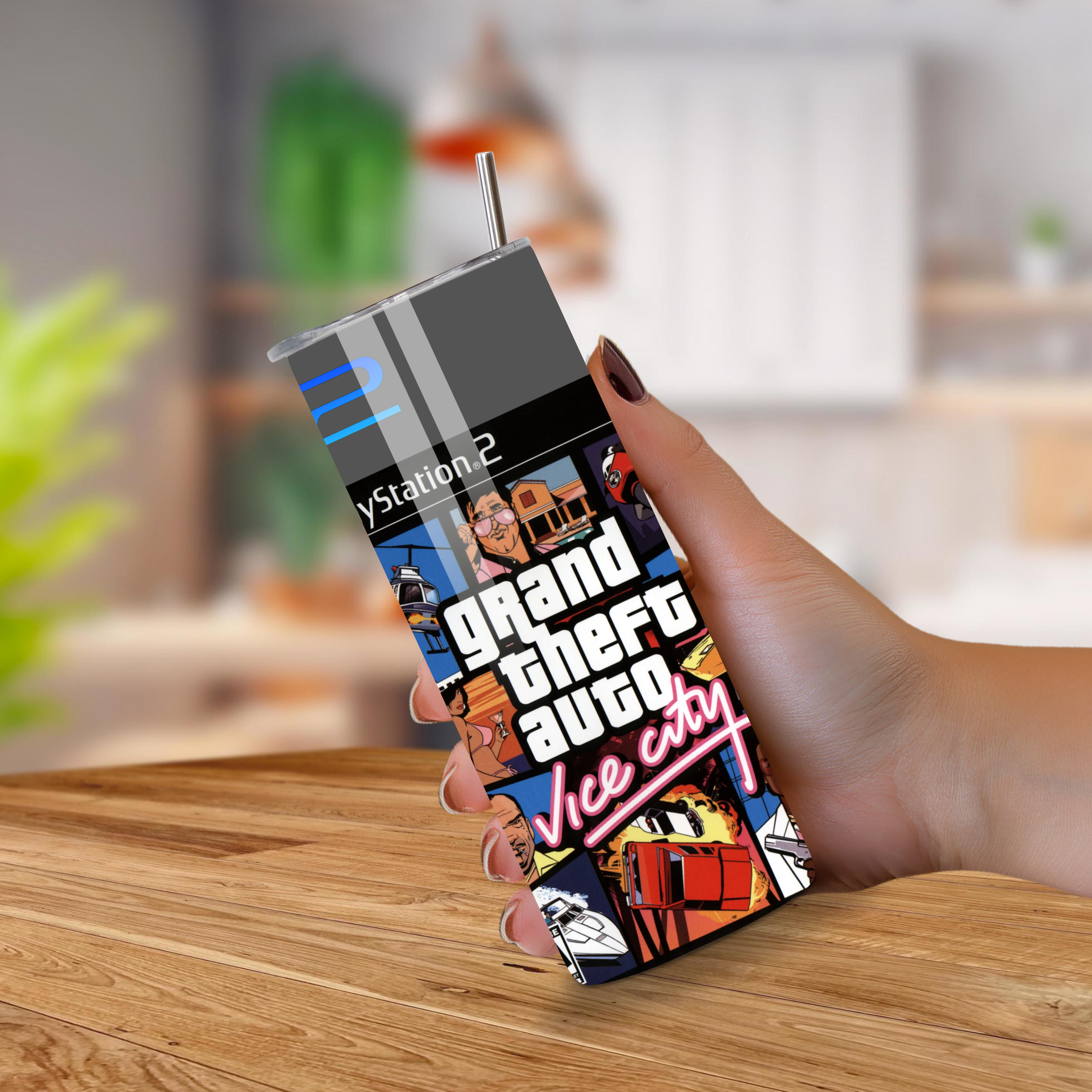 20oz Tumbler with Grand Theft Auto Vice City design held by a hand on a wooden surface.