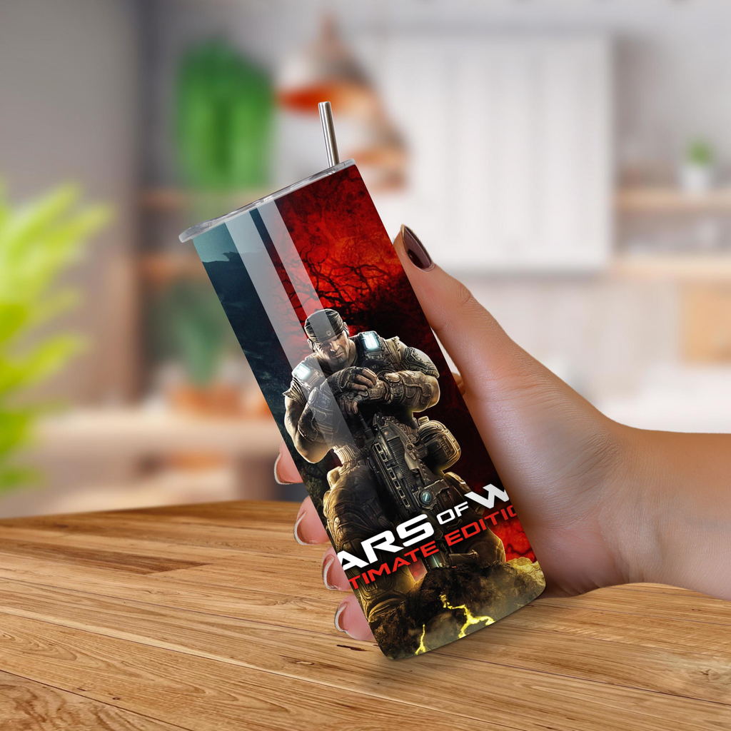 Tumbler with 'Gears of War' design held by a hand on a wooden surface.