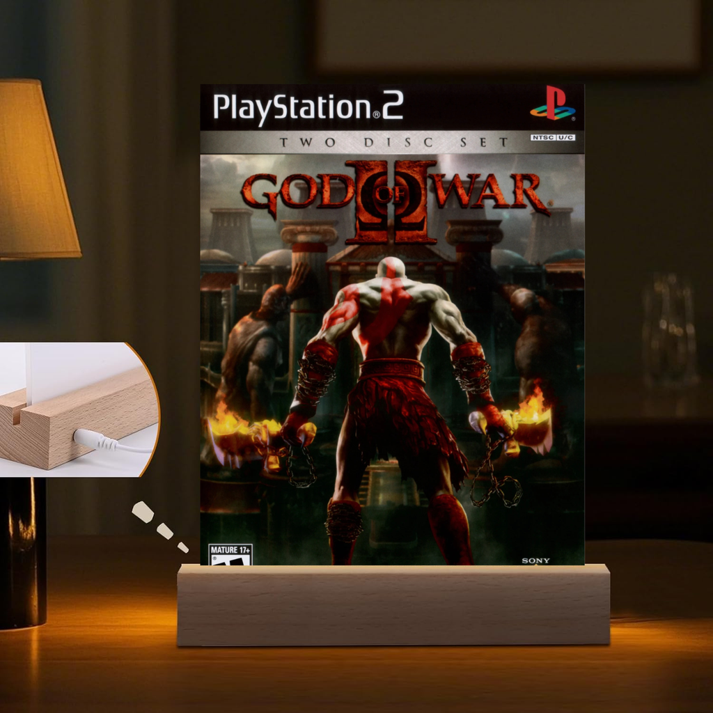 PlayStation 2 'God of War II' night light set on a stand with a warm glow.