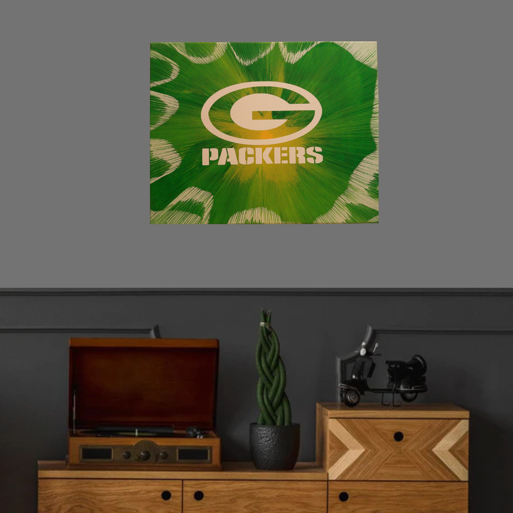 Green Bay Packers Spin Art above a wooden cabinet with decorative items.