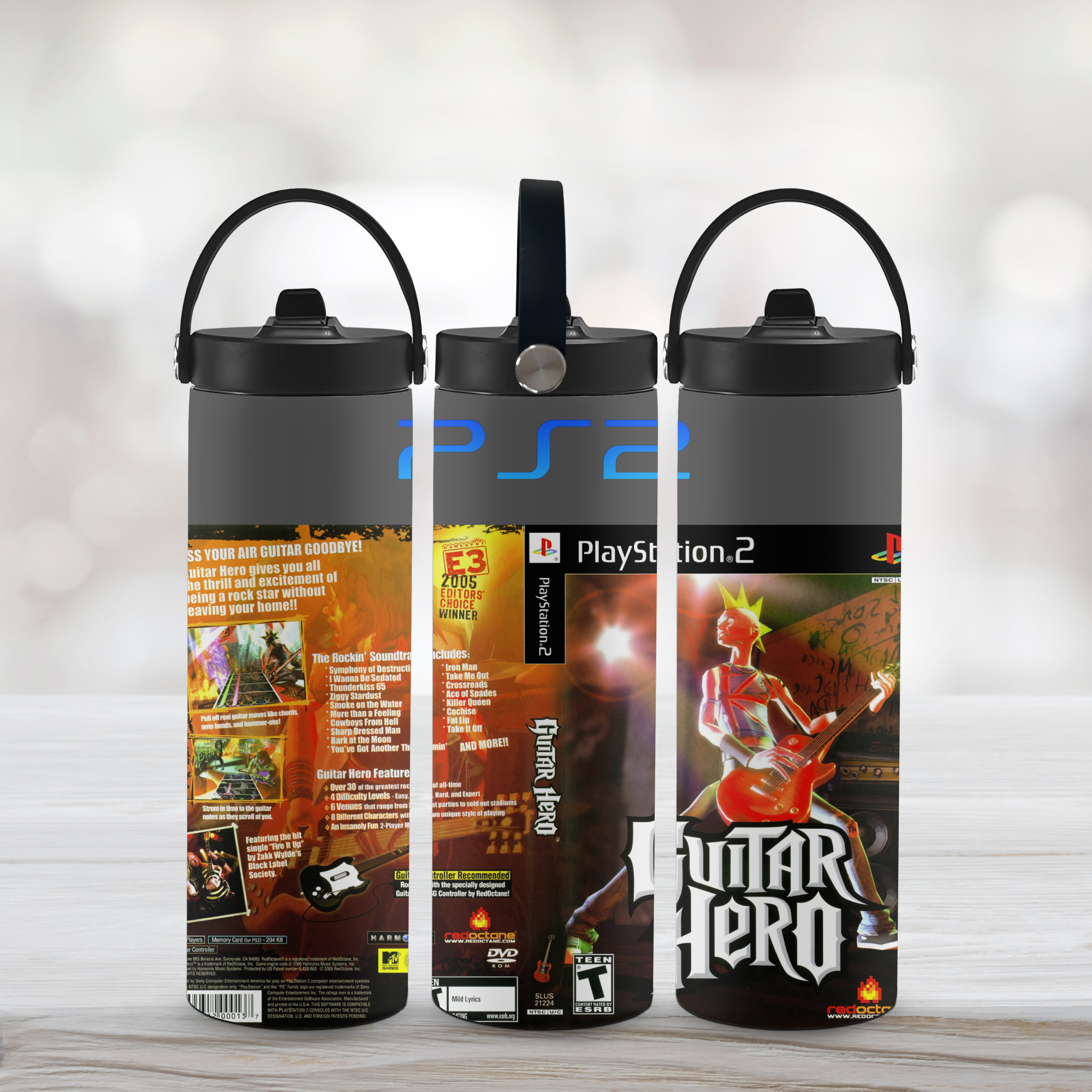Three water bottles with PlayStation 2 and Guitar Hero branding on a light wooden surface.