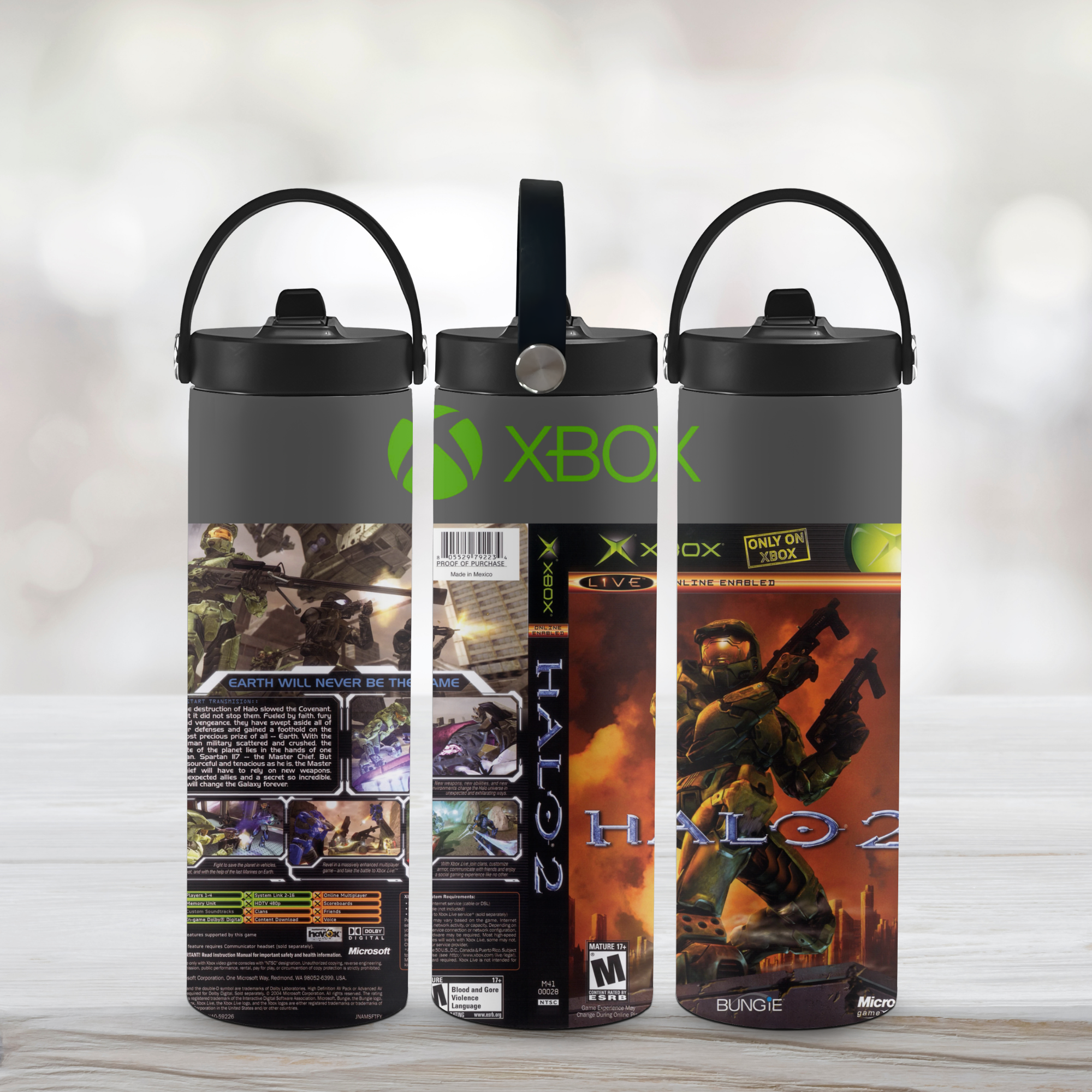 Three black water bottles with Xbox and Halo 2 branding on a light wooden surface.