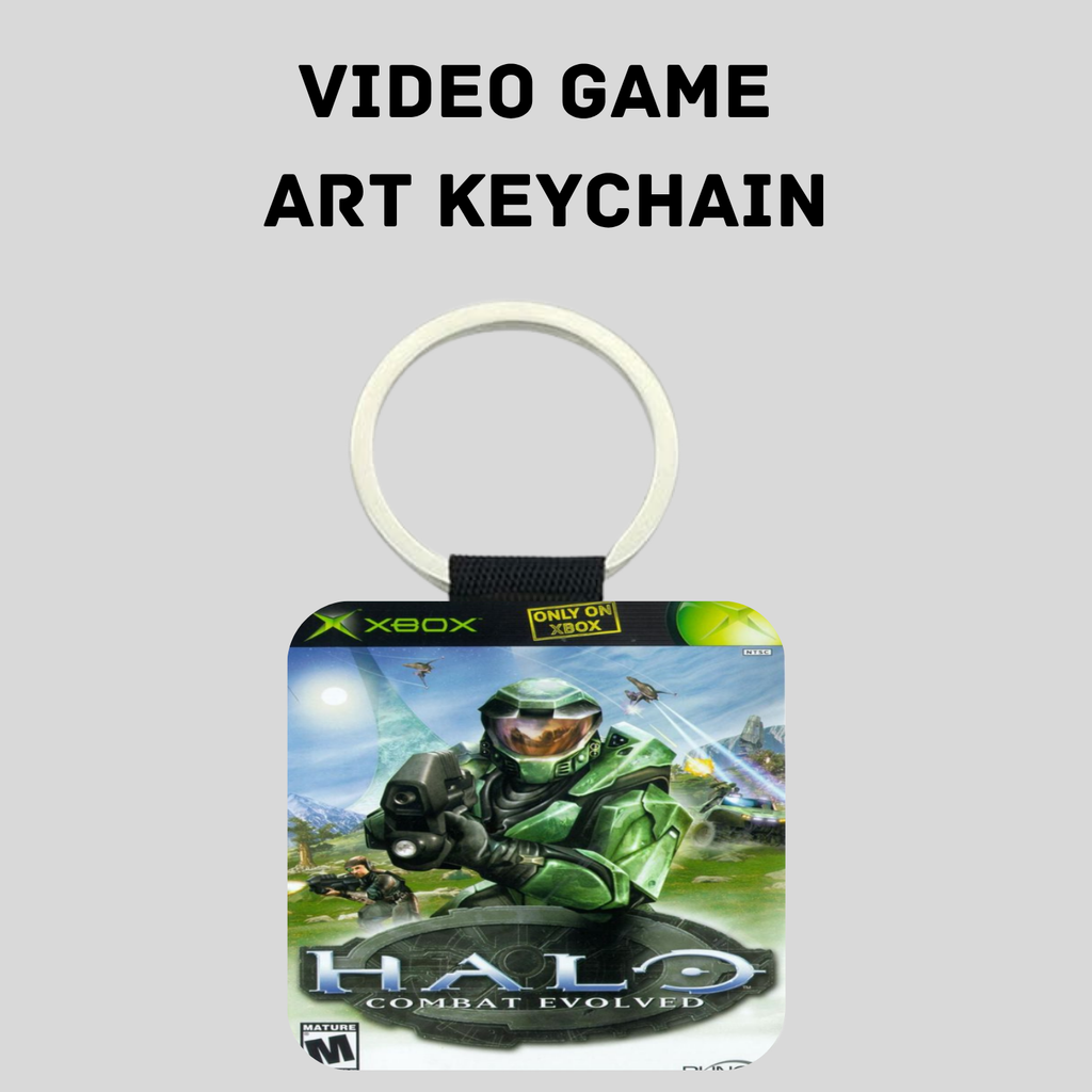 A Halo video game art keychain featuring artwork from Halo Combat Evolved on a square tag with a white key ring and black strap, shown on a light gray background with the text 'VIDEO GAME ART KEYCHAIN' above it.
