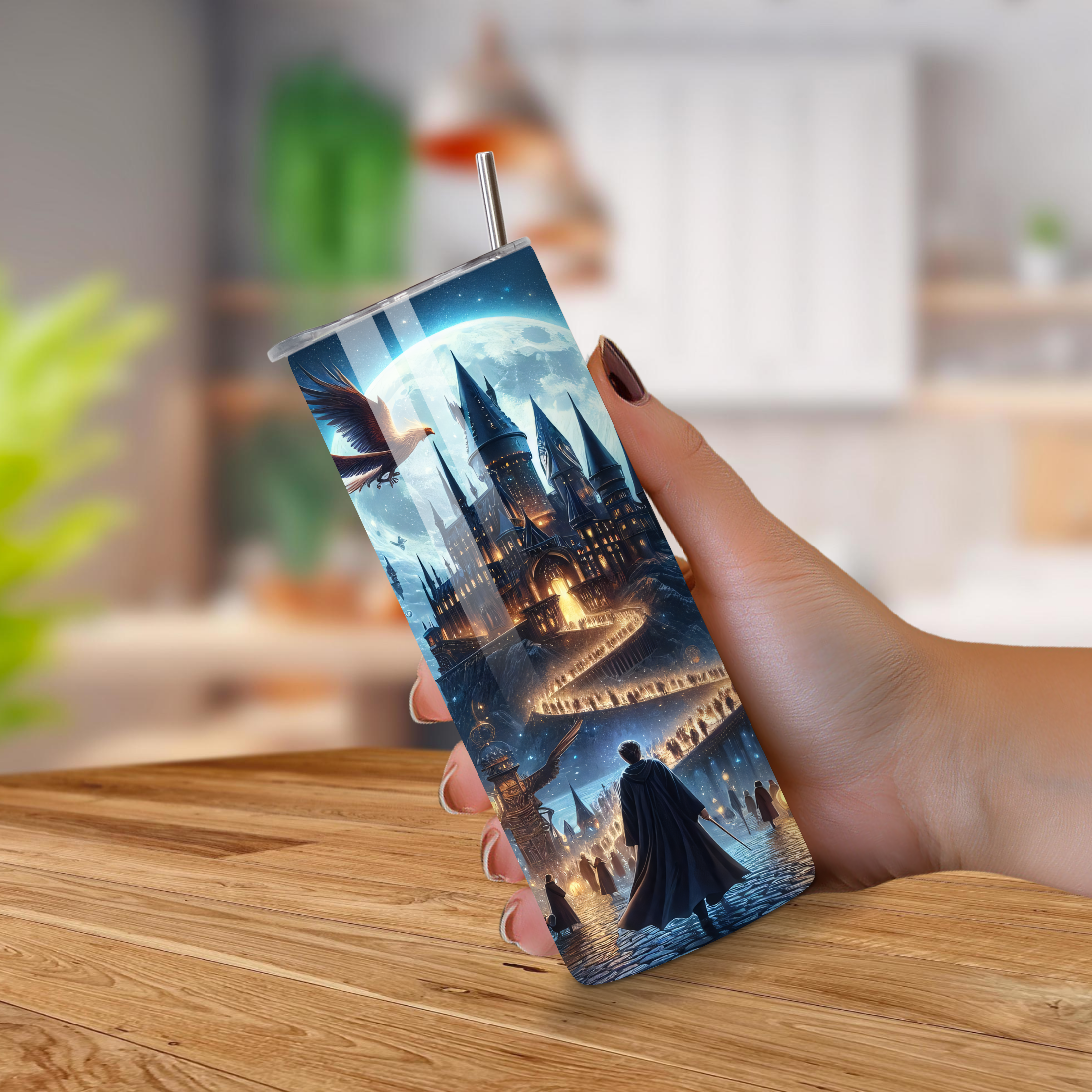 20 oz tumbler with a fantasy castle design held by a hand on a wooden surface.