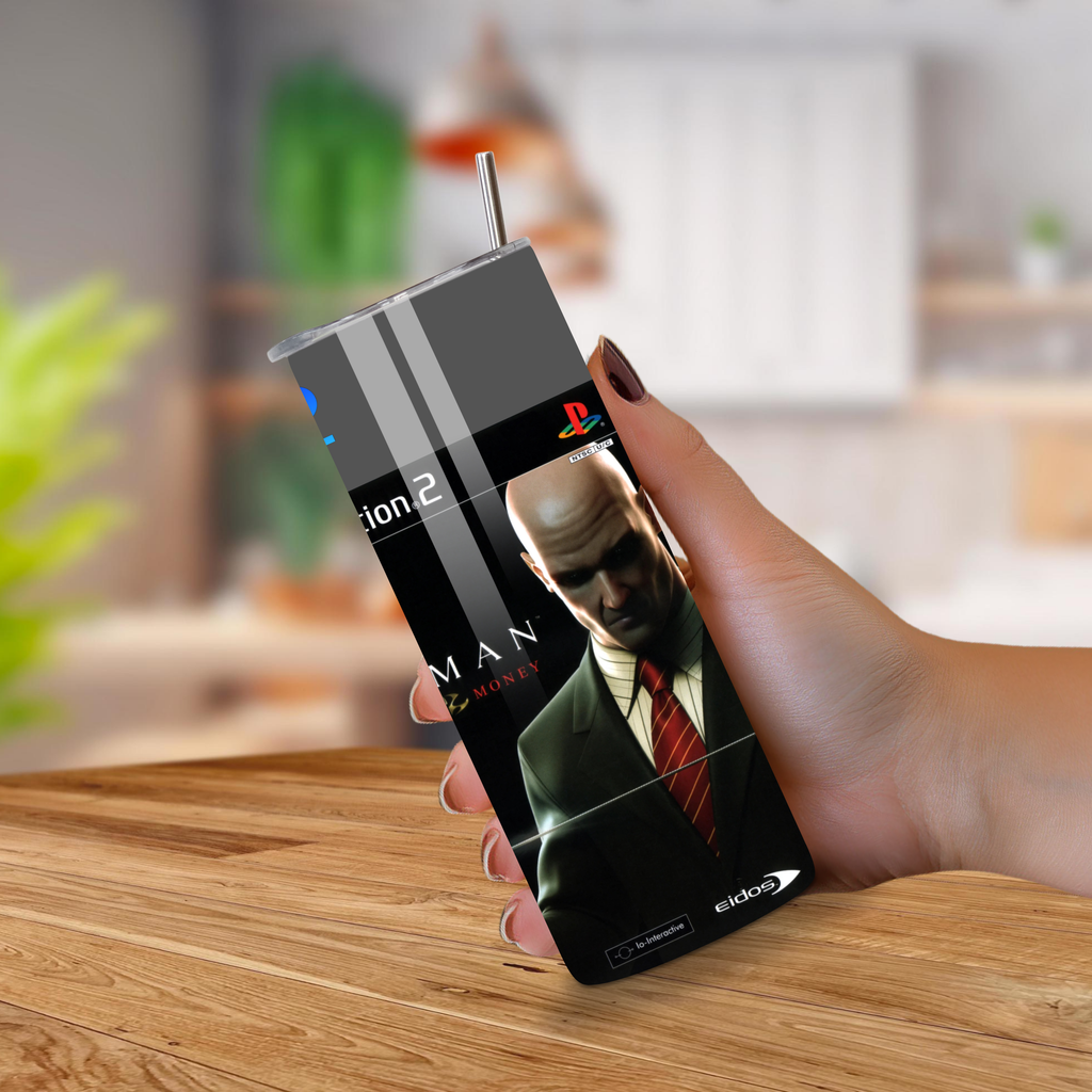 20oz tumbler with a Hitman Blood Money design held by a hand on a wooden surface