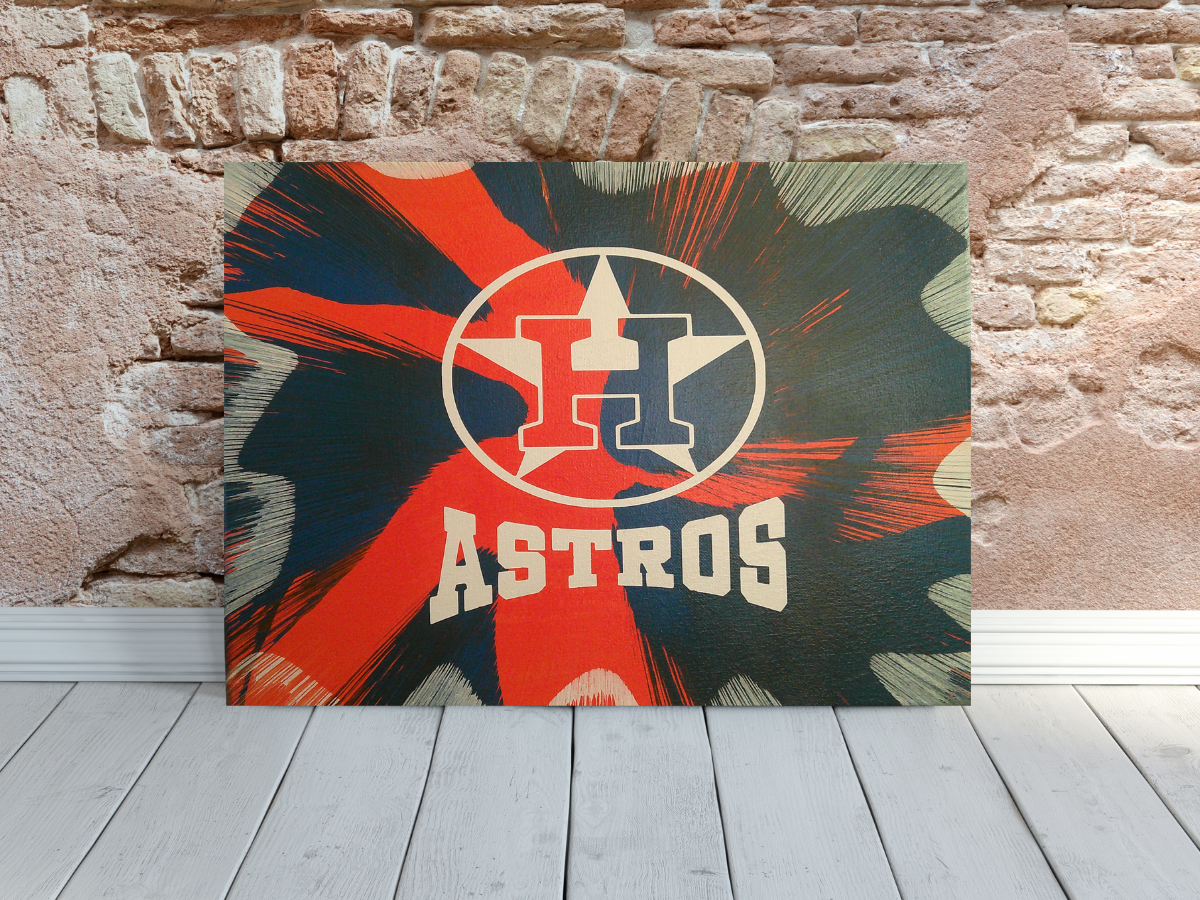 Houston Astros Spin Art canvas wall art leaning against a brick wall.