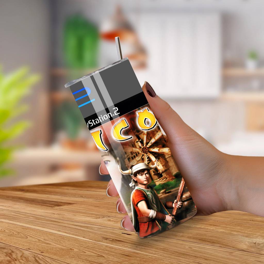 Hand holding a 20oz tumbler ICO design on a wooden surface