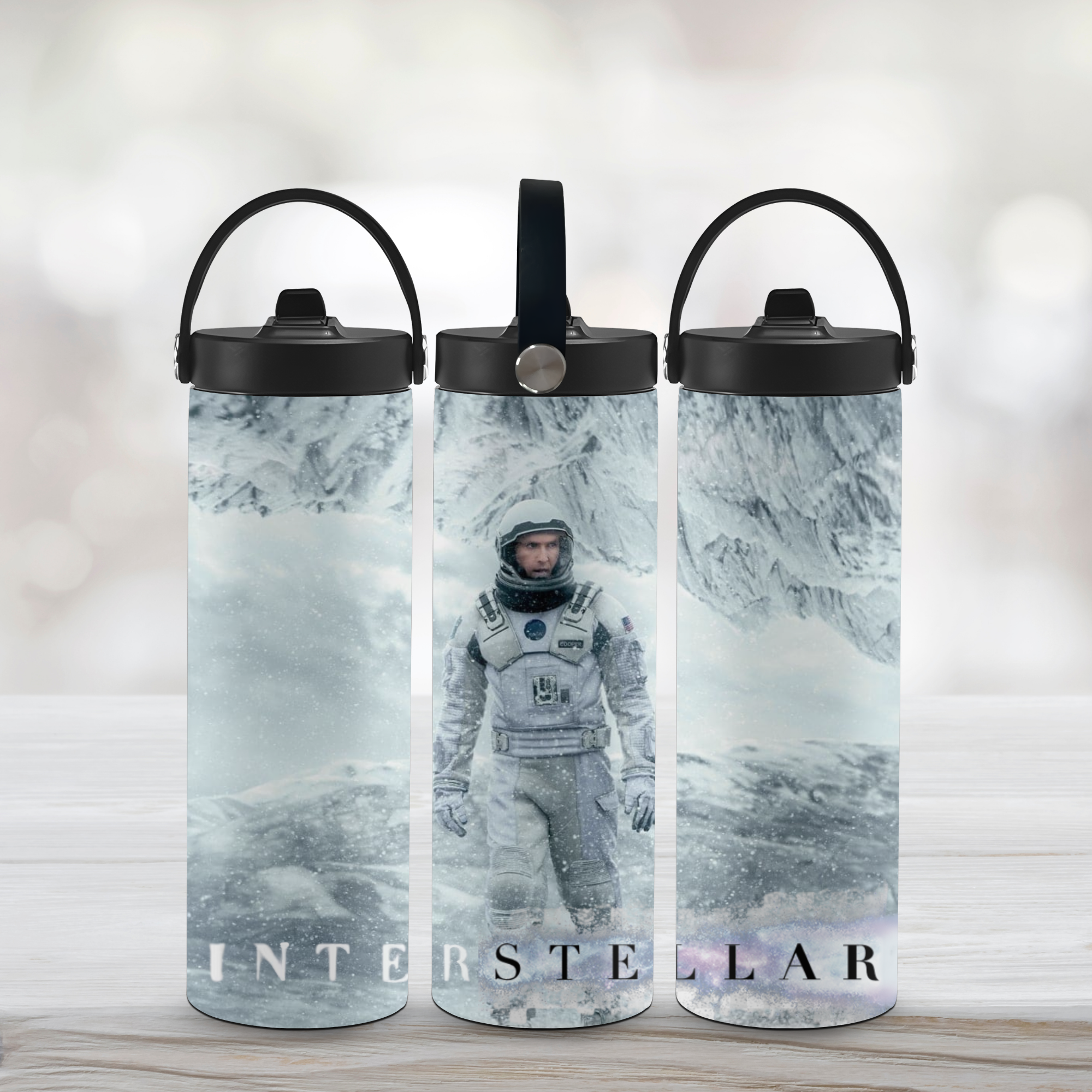 Three water bottles with 'Interstellar' movie design featuring an astronaut in space suit.