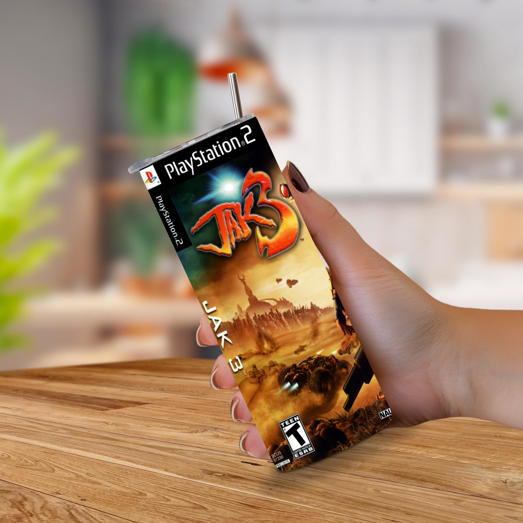 A hand holding a 20oz tumbler designed to look like Jak 3 PlayStation 2 video game on a blurred kitchen background.