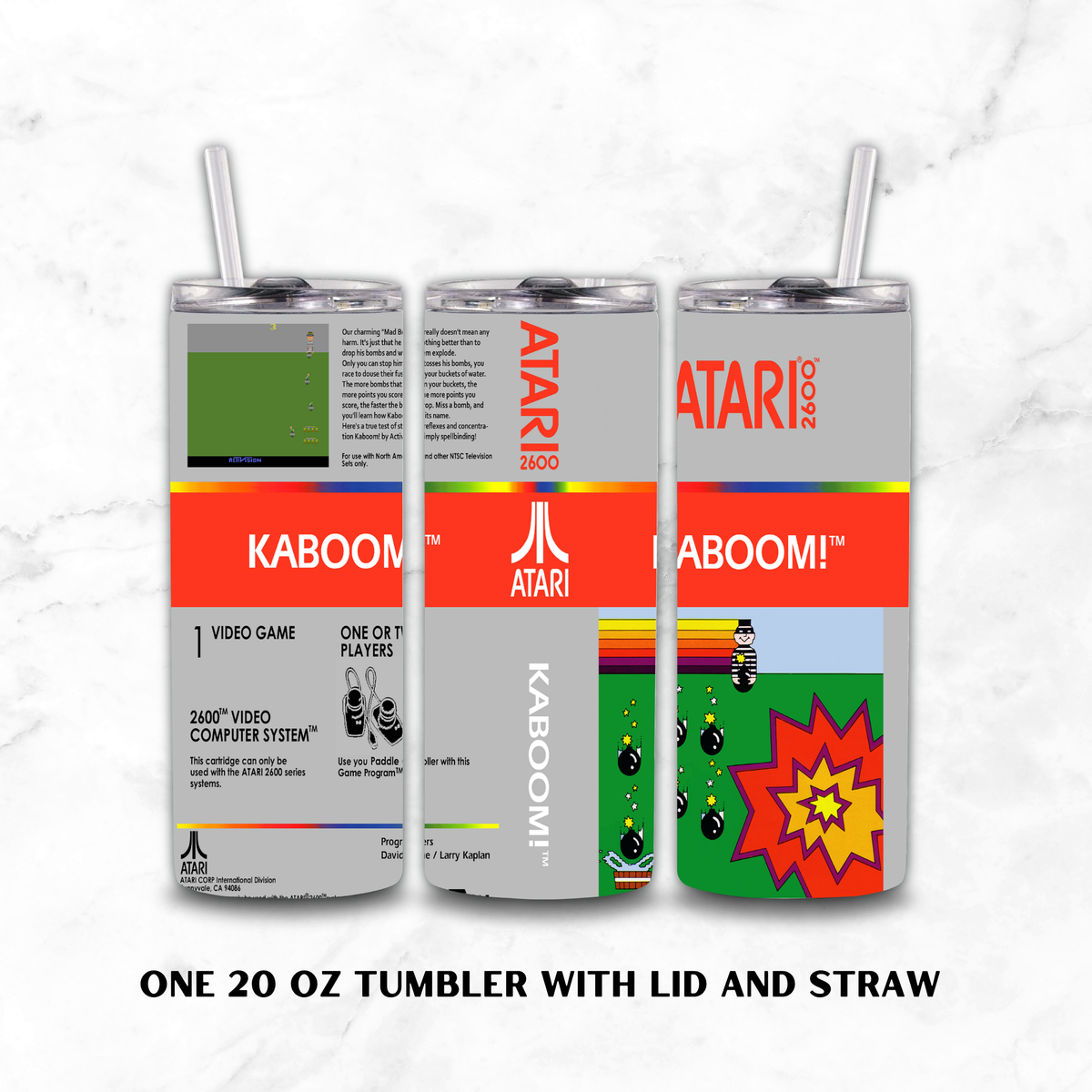 Three views of a 20 oz stainless steel tumbler with lid and straw, featuring a retro Atari-style label design for KABOOM!, on a white marble background.