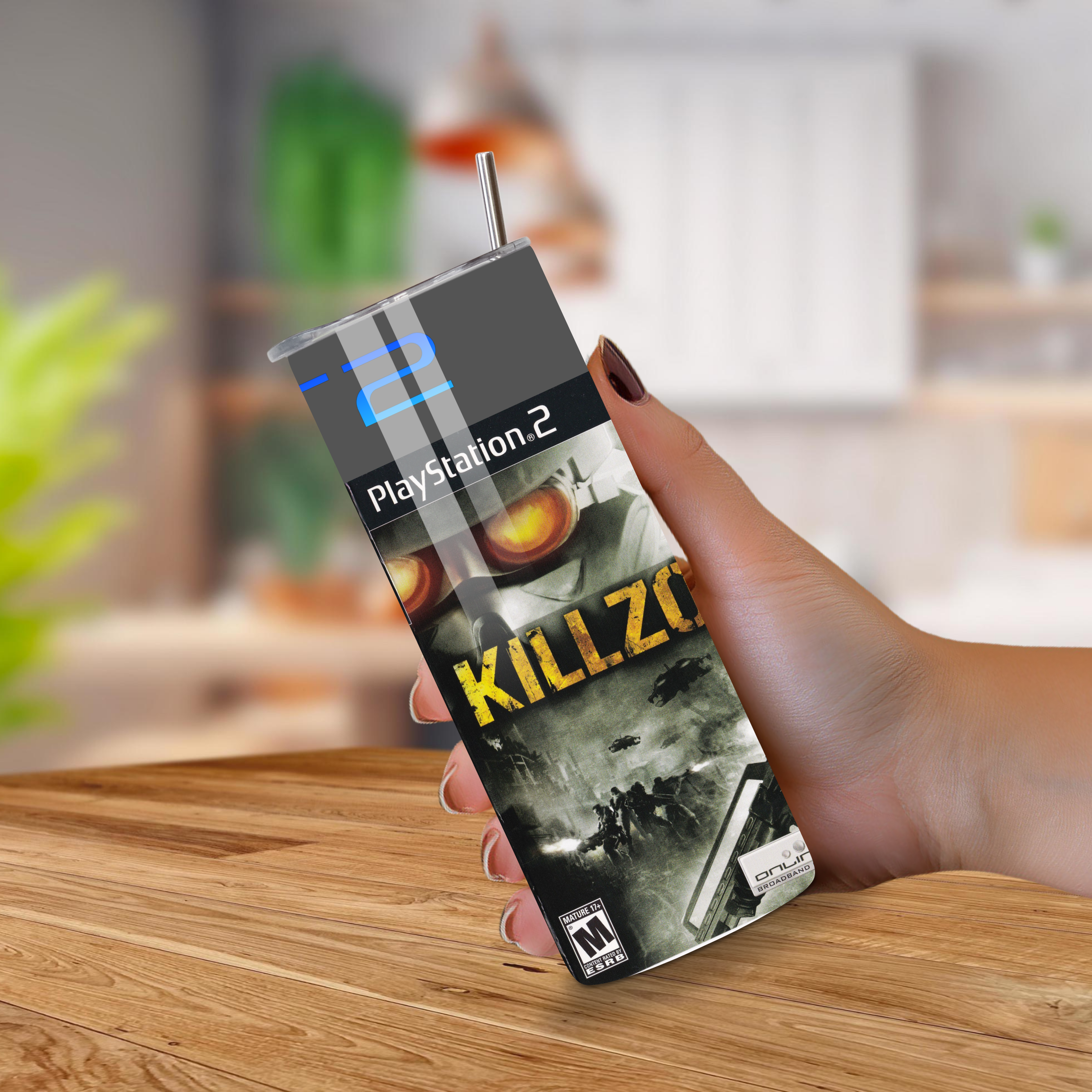 PlayStation 2 20oz tumbler for 'Killzone' held by a hand on a wooden surface.