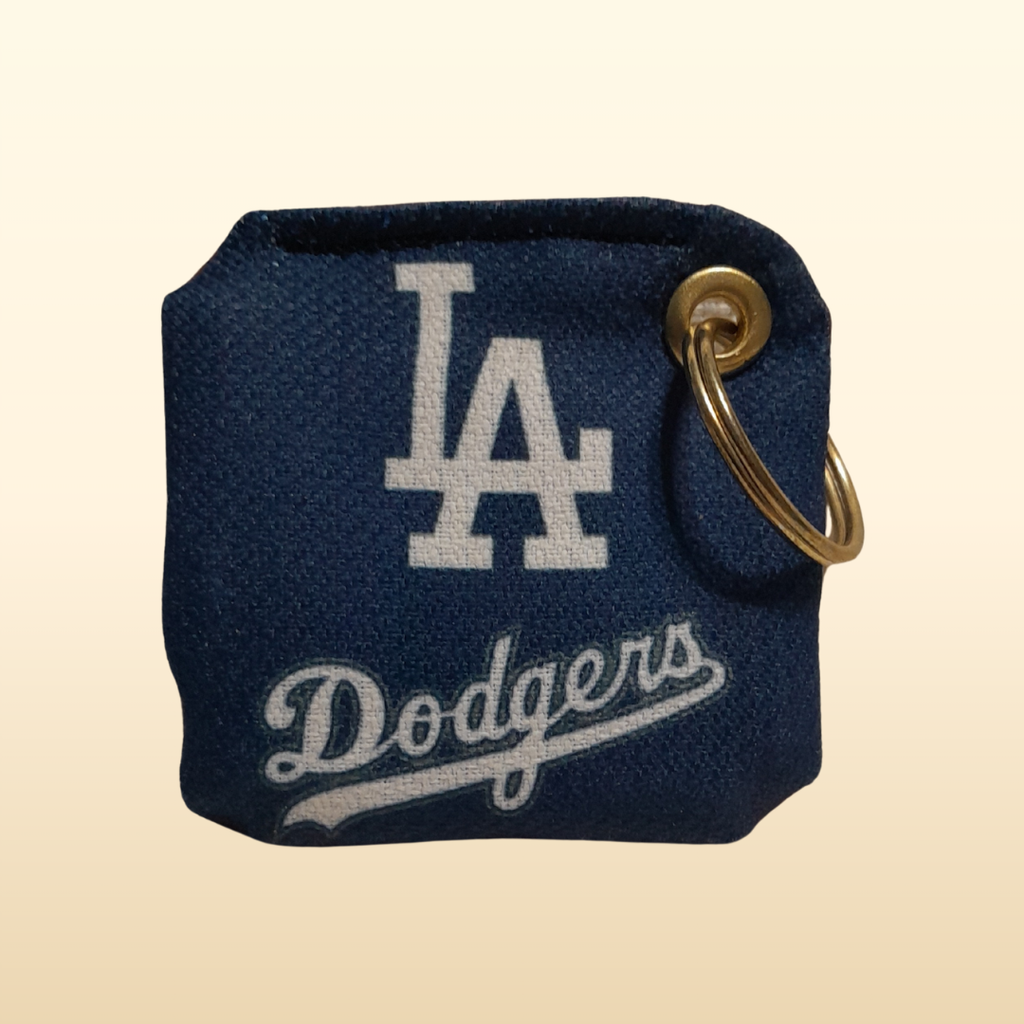 Navy blue keychain pouch with LA Dodgers logo on a beige background