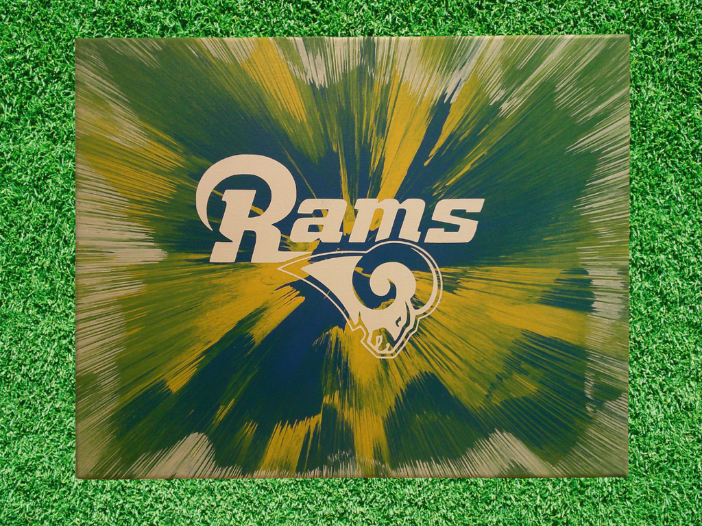 LA Rams logo Spin Art on a green grass background