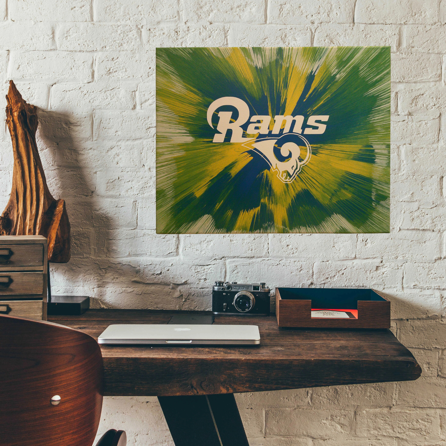 LA Rams Spin Art canvas on a white brick wall above a deck