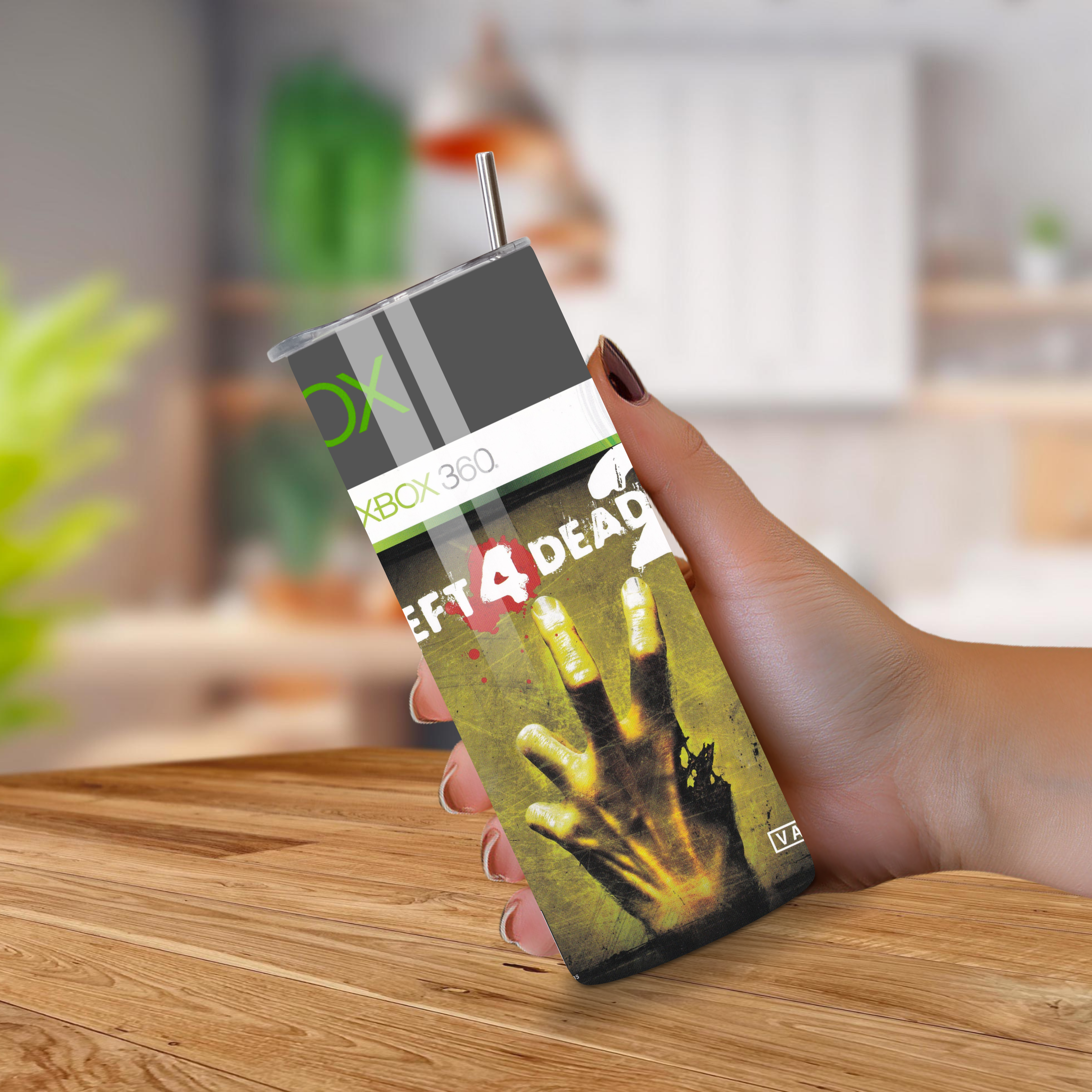 Person holding a 20oz tumbler with 'Left 4 Dead 2' design on a wooden surface