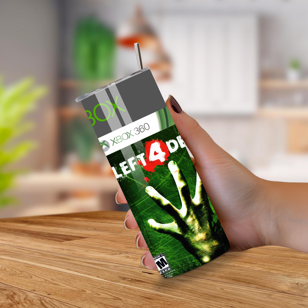 Hand holding a custom Xbox 360 tumbler with 'Left 4 Dead' design on a wooden surface