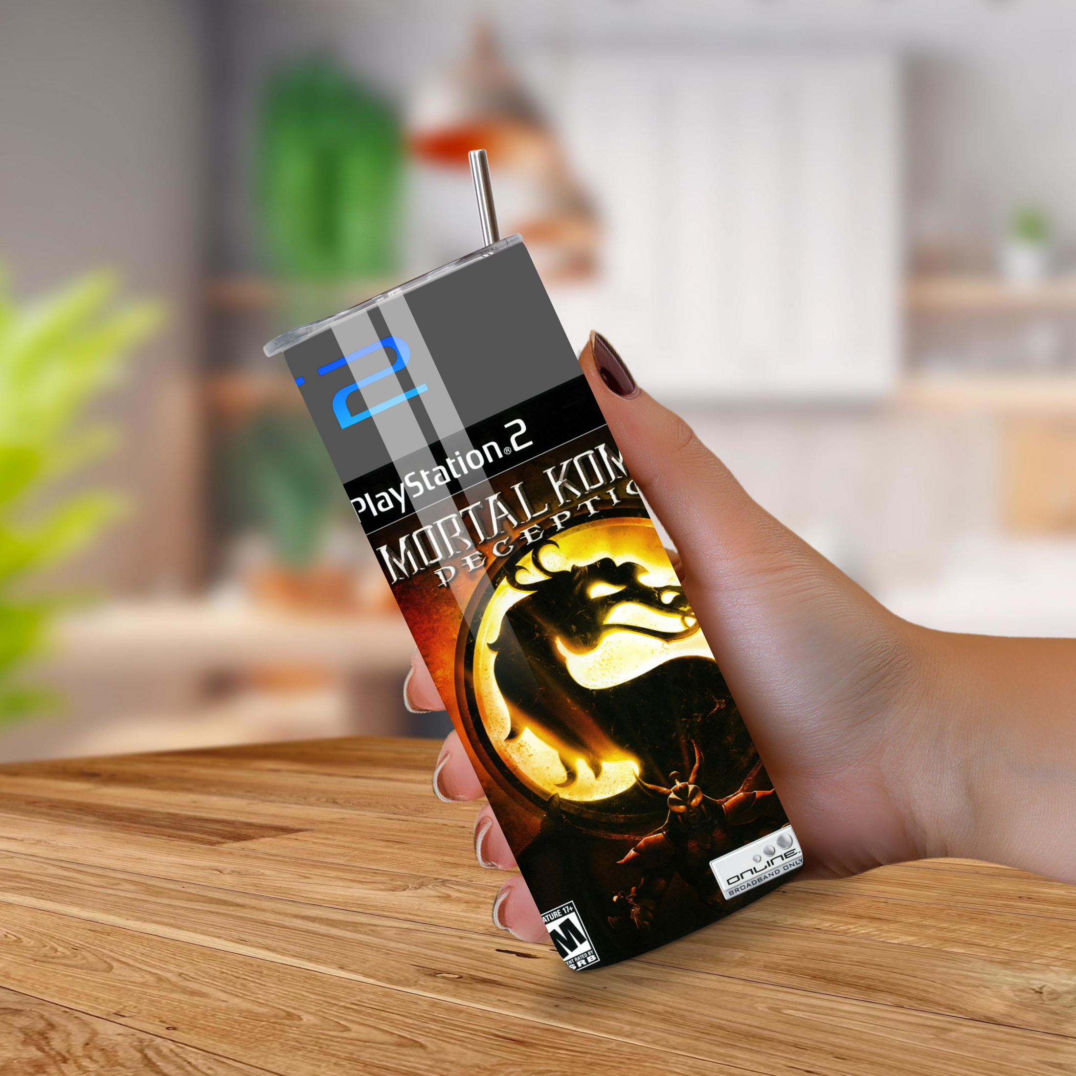 20oz tumbler with Mortal Kombat design held by a hand on a wooden surface.