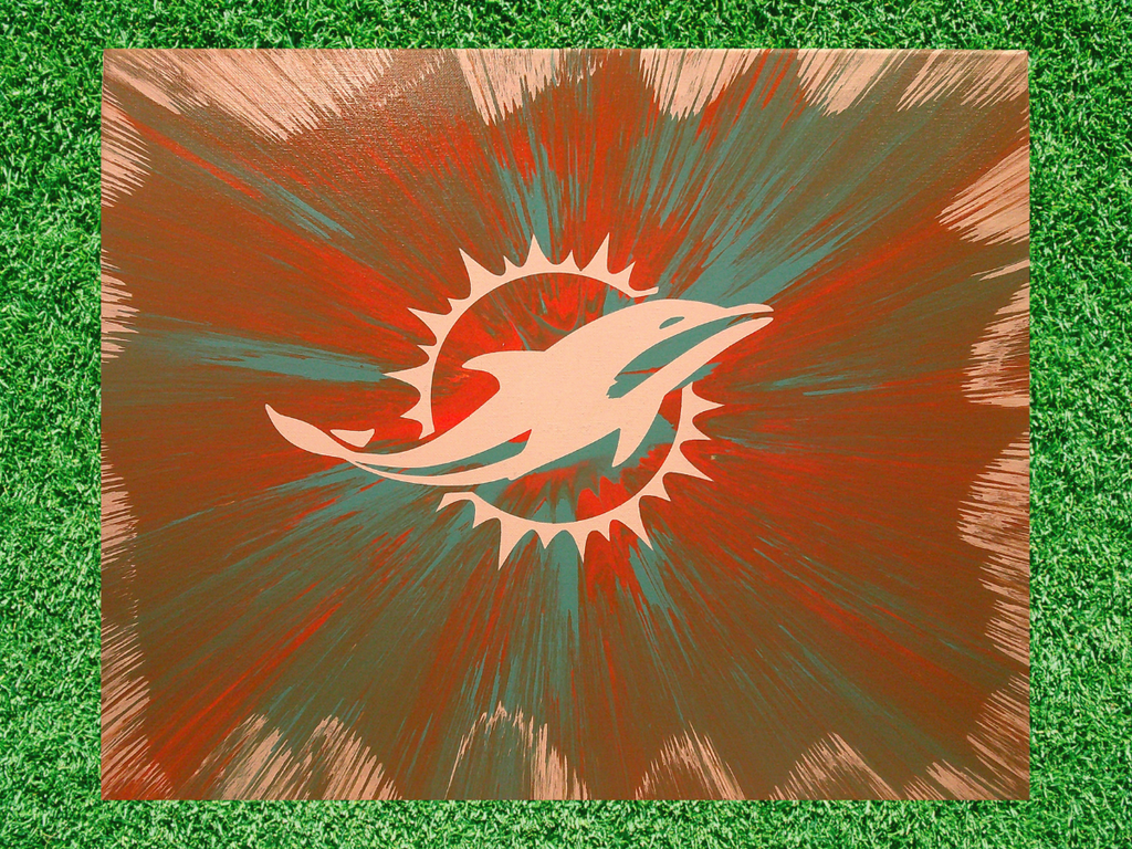 Spin Art design of the Miami Dolphins logo on a green grass background