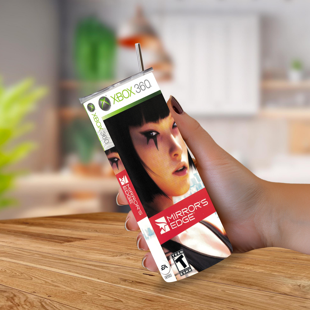 A hand holding a 20oz tumbler styled like the Xbox 360 game Mirror's Edge, with a straw and printed game cover art, against a blurred indoor background.