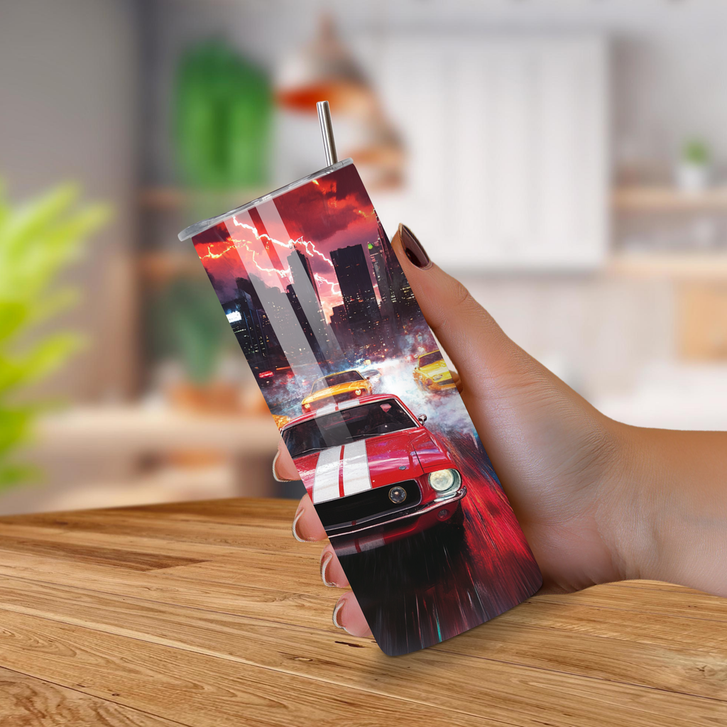 Person holding a tumbler with a car design on a wooden table