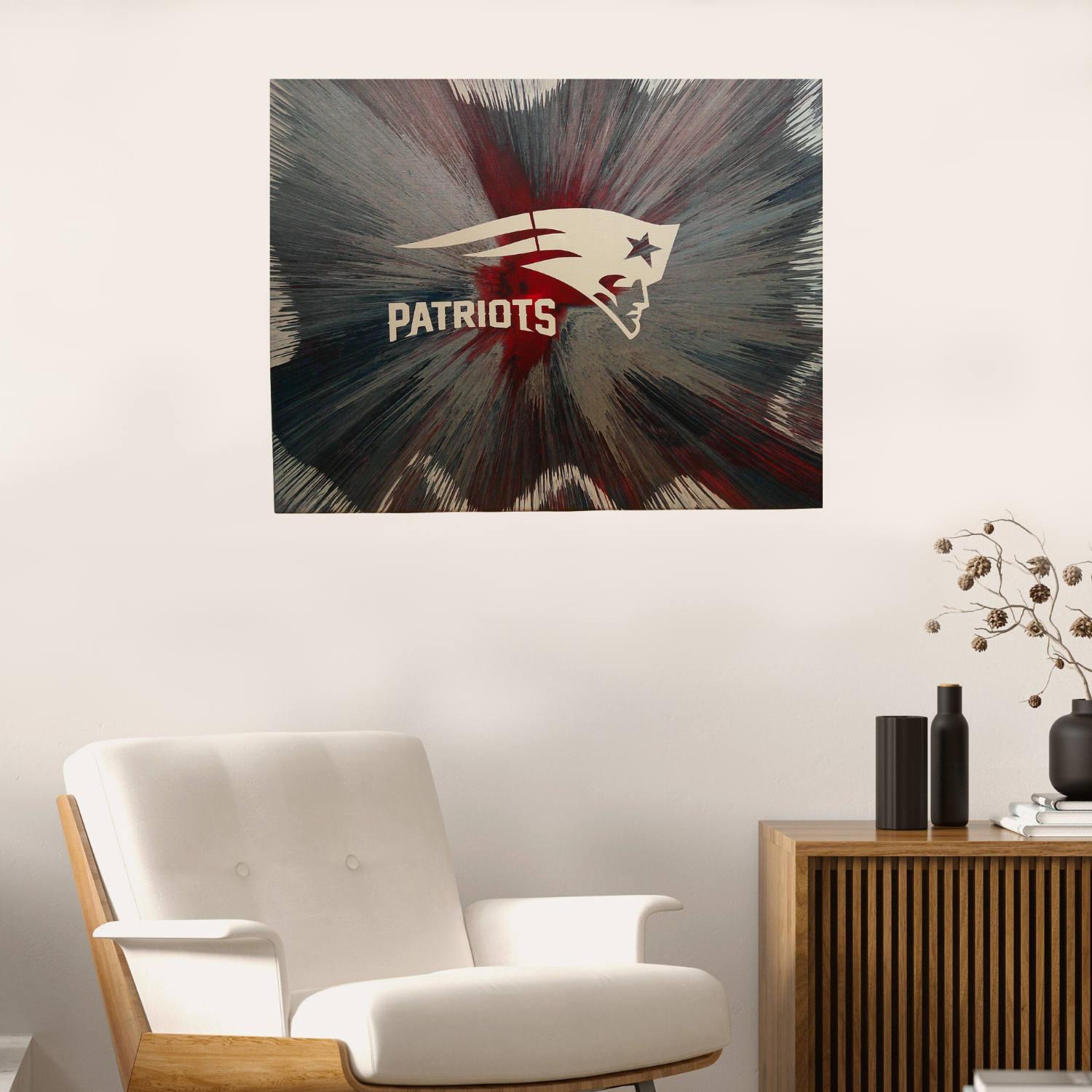 New England Patriots Spin Art on a white wall above a white armchair.