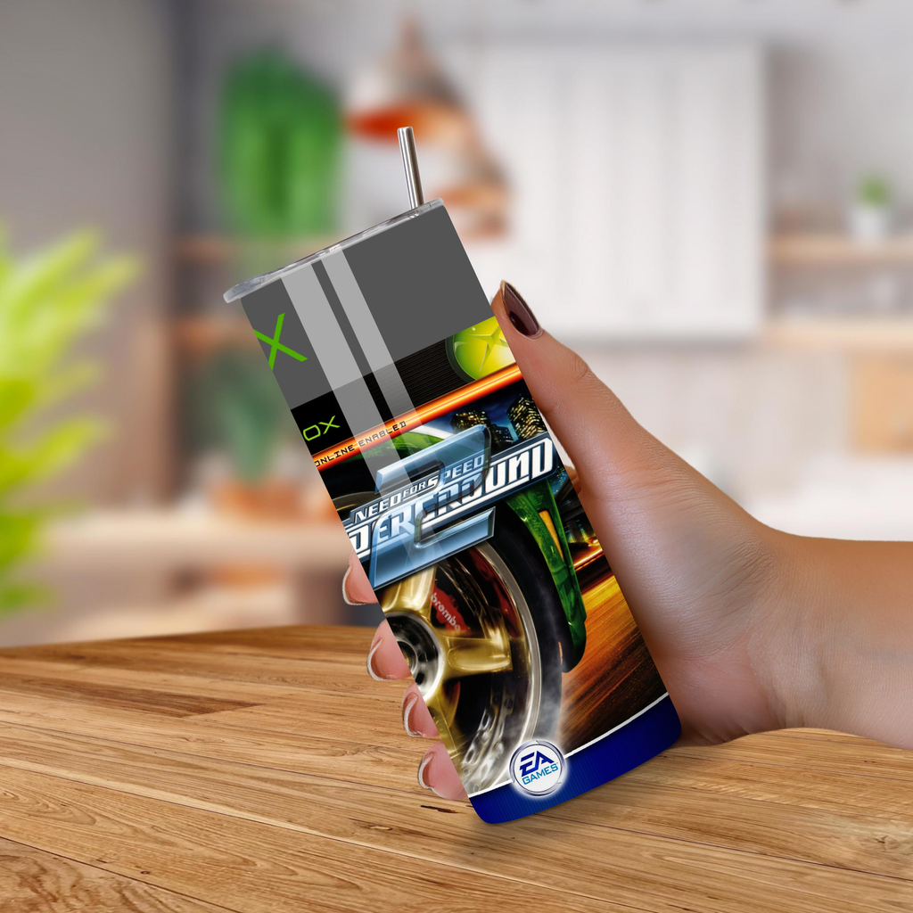 Hand holding a 20oz tumbler with a Need for Speed game design on a wooden surface