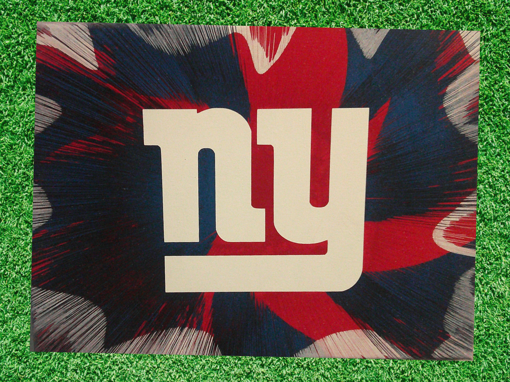 New York Giants Spin Art canvas wall art on a green grass background. 