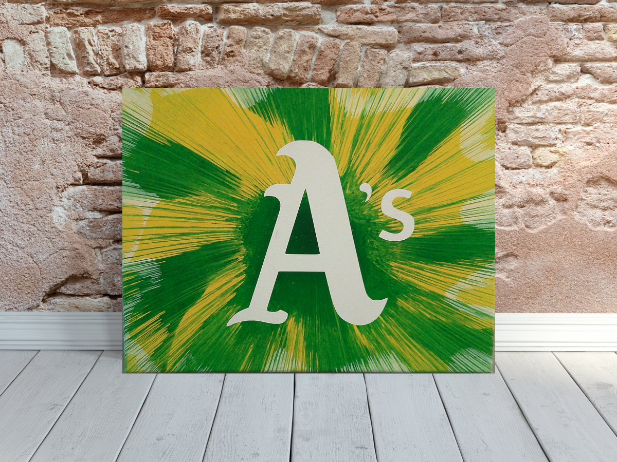 Oakland Athletics spin art canvas wall art leaning on a brick wall. 