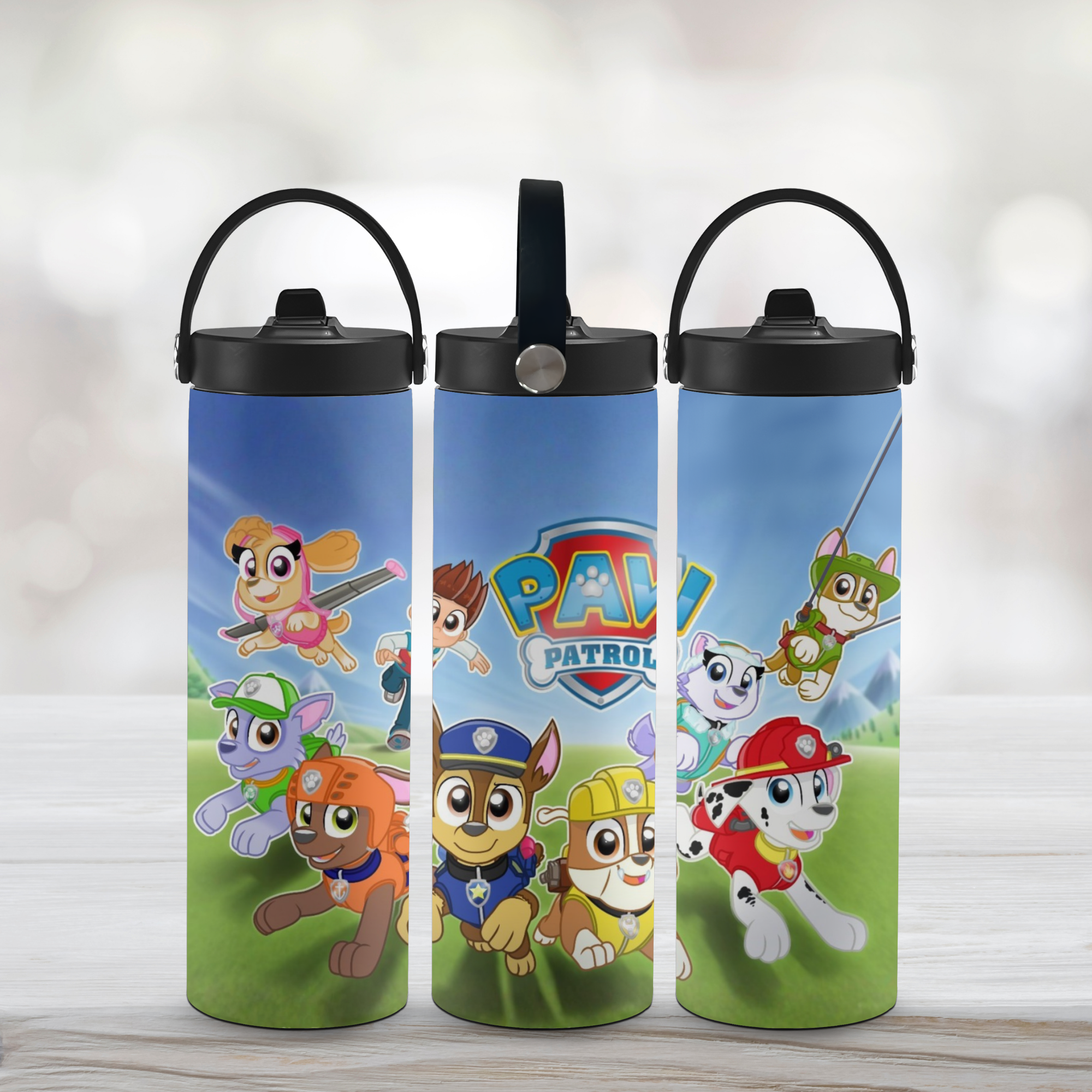 Three sports water bottles with Paw Patrol design on a light background