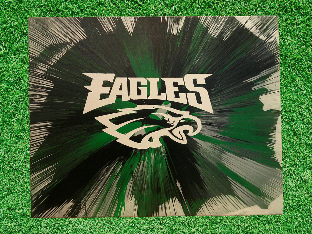 Custom Spin Art Eagles logo with dynamic team colors background on green grass