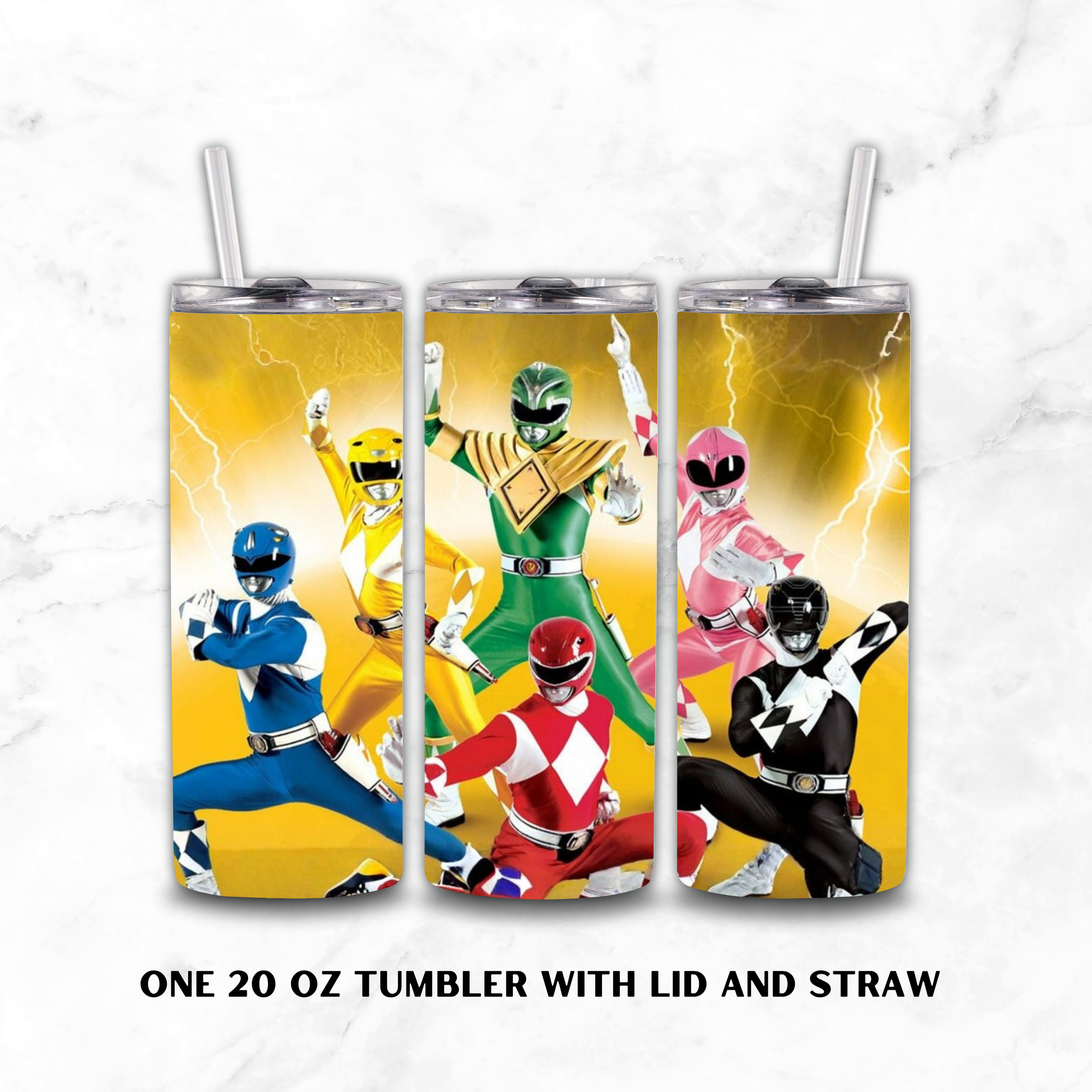 Three 20 oz tumblers with lids and straws, each printed with a different Power Ranger character on a yellow lightning background. The tumblers are shown side by side on a white marble surface, with text below reading 'ONE 20 OZ TUMBLER WITH LID AND STRAW'.