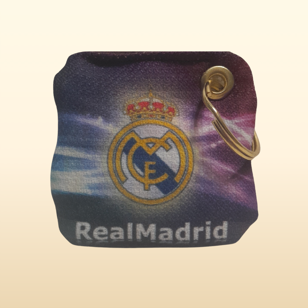 Real Madrid logo on a keychain pouch with a purple and blue gradient background