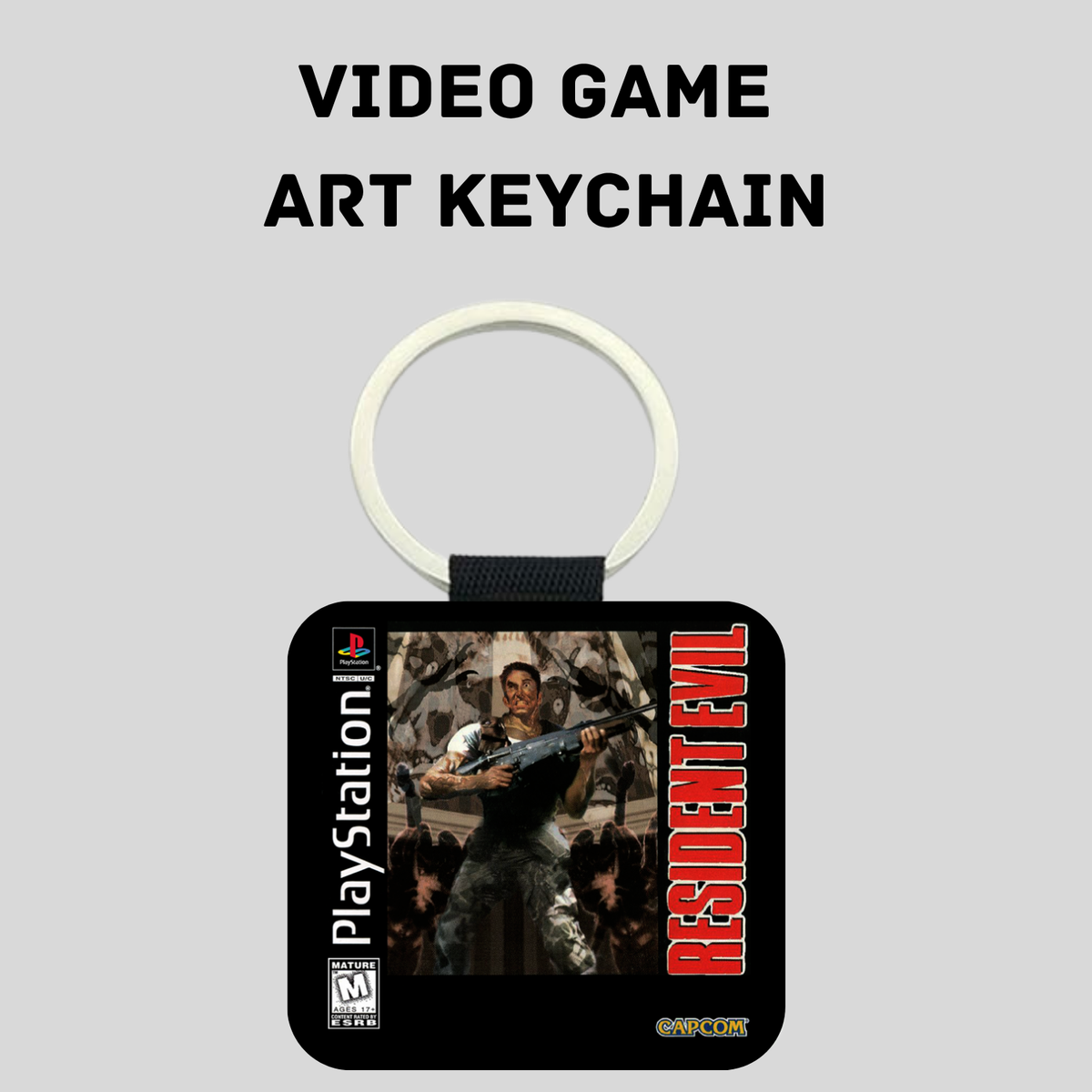 A PlayStation 1 Resident Evil video game art keychain on a light gray background with the text 'VIDEO GAME ART KEYCHAIN' above it. The keychain has a split ring, a black strap, and a square black pendant featuring artwork from the game with the PlayStation and Resident Evil branding.