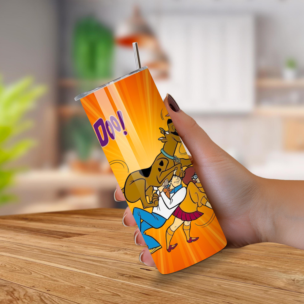 Scooby Doo 20 oz Tumbler held by a hand on a wooden surface.