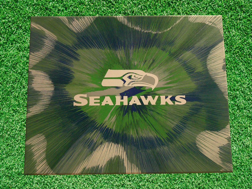 Spin Art design with Seahawks logo on a green grass background