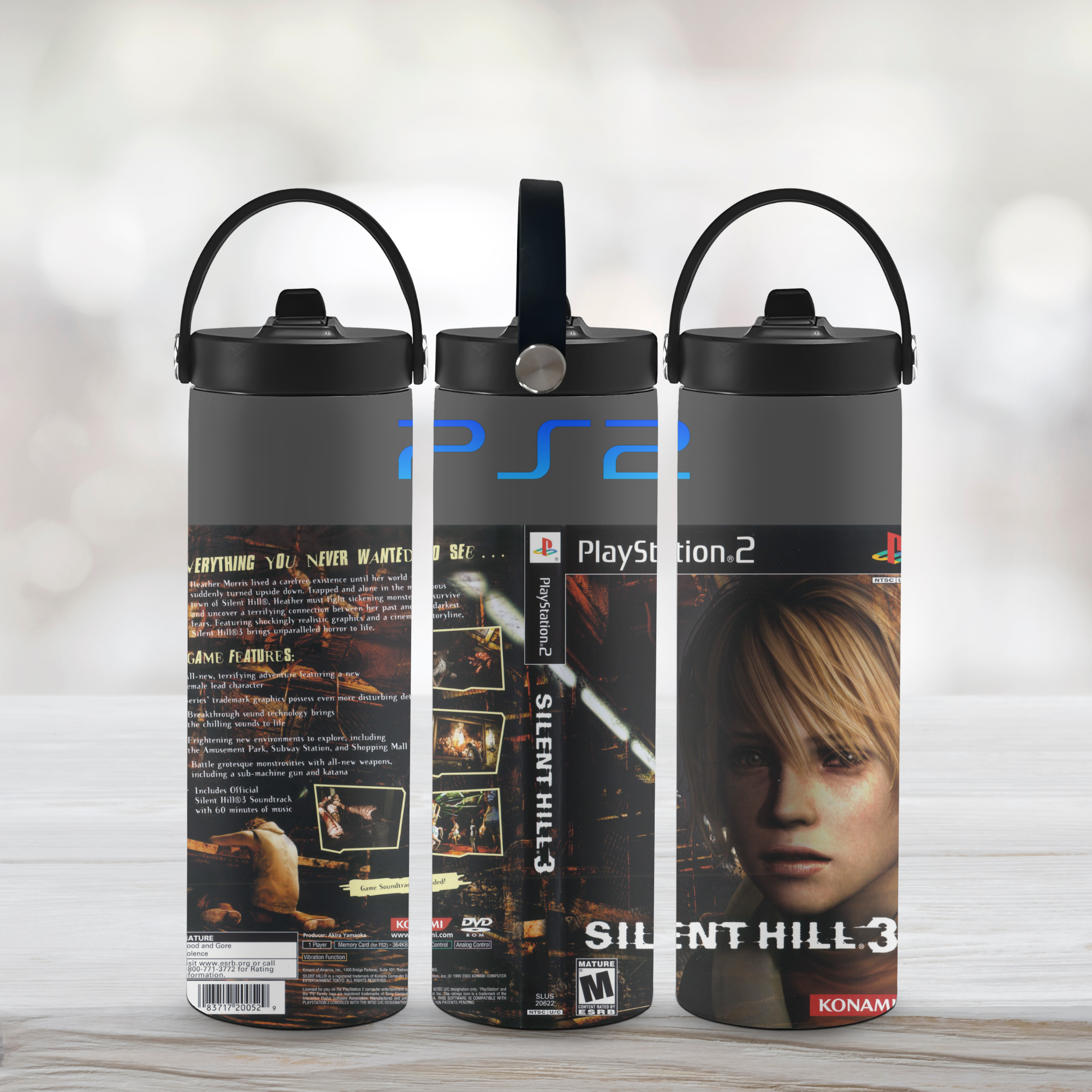 Three sports water bottle designs inspired by 'Silent Hill 3' and PlayStation 2 branding on a light wooden surface.