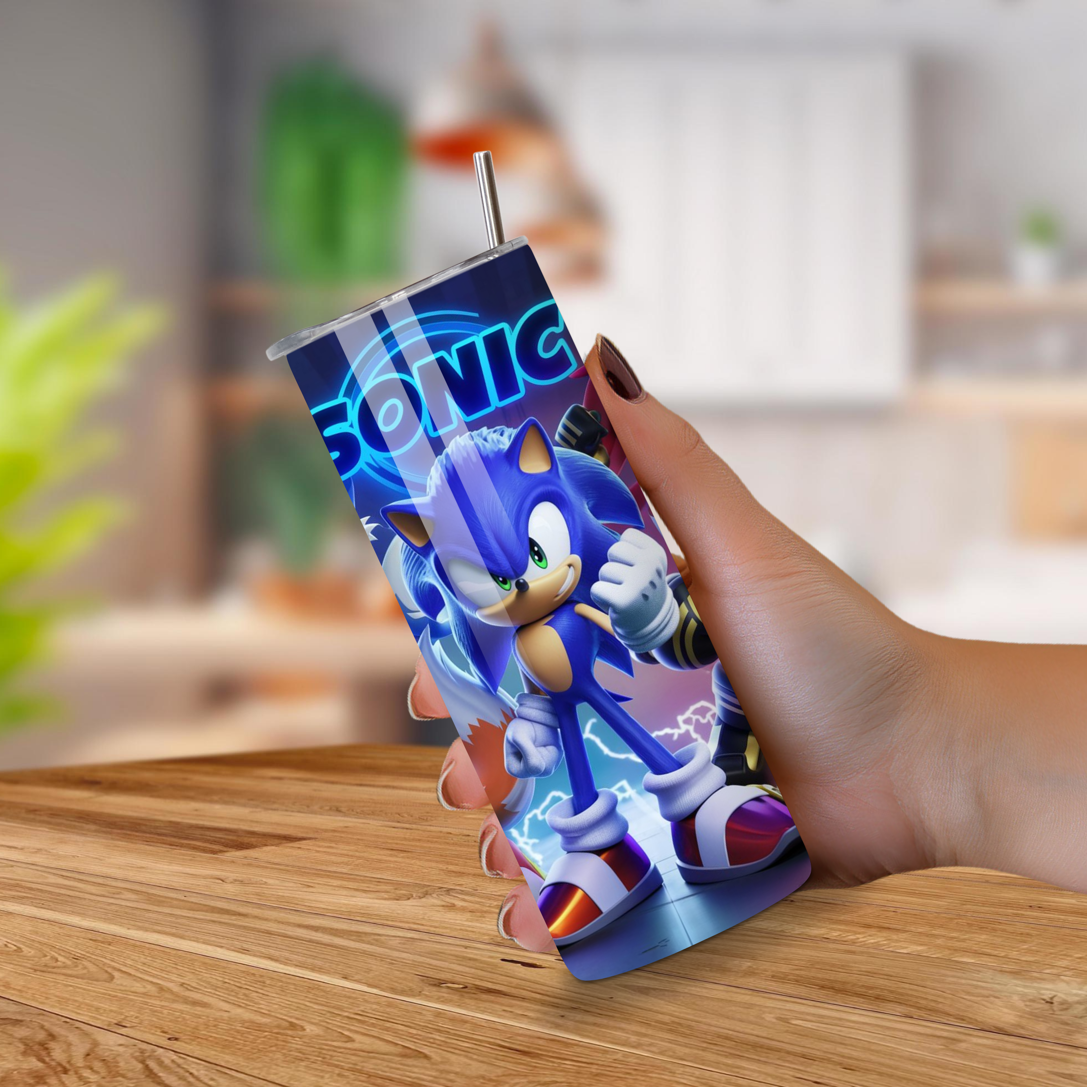 Tumbler with Sonic the Hedgehog design held by a hand on a wooden surface.