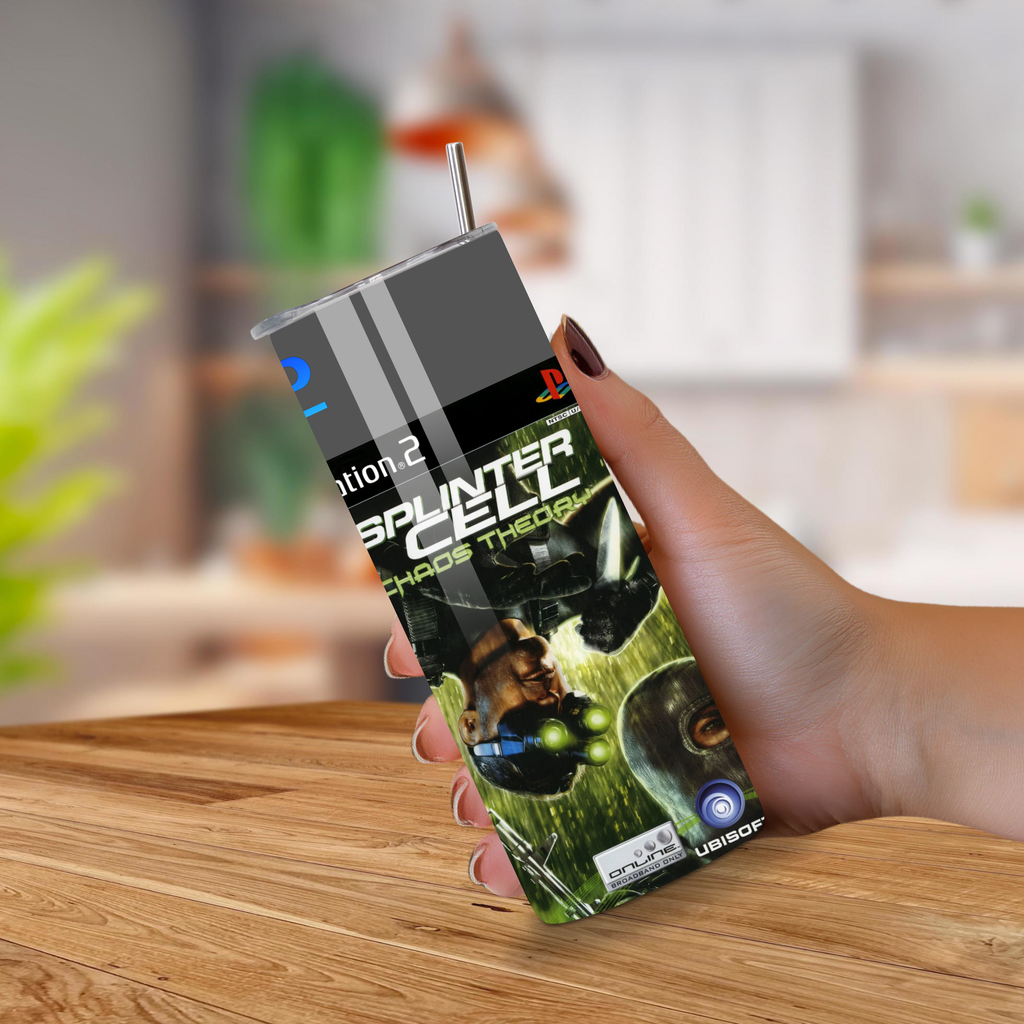 Person holding a 20oz tumbler with a Splinter Cell-themed on a wooden surface.