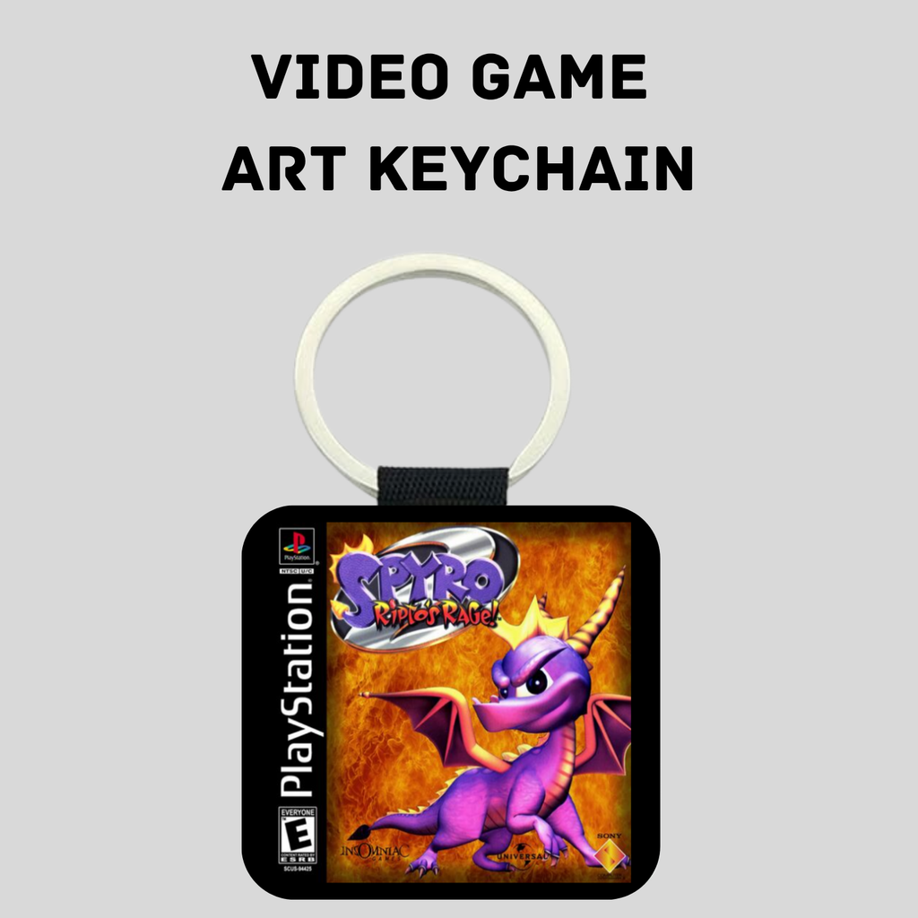 A square video game art keychain featuring Spyro from PlayStation's Spyro Ripto's Rage, with a white key ring and black strap, shown on a light gray background with the text 'VIDEO GAME ART KEYCHAIN' above it.