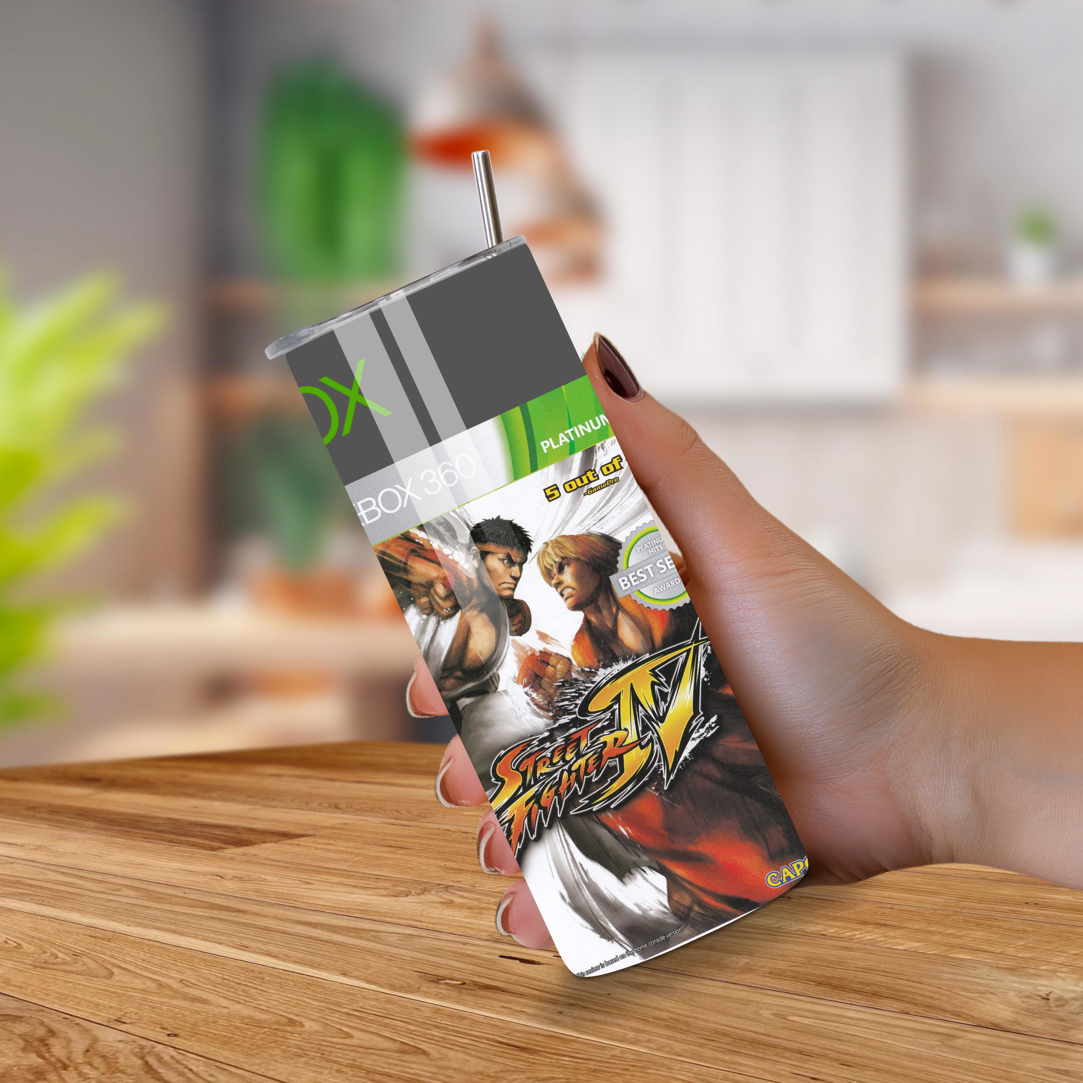 Hand holding a Street Fighter-themed 20oz tumbler on a wooden surface with a blurred background
