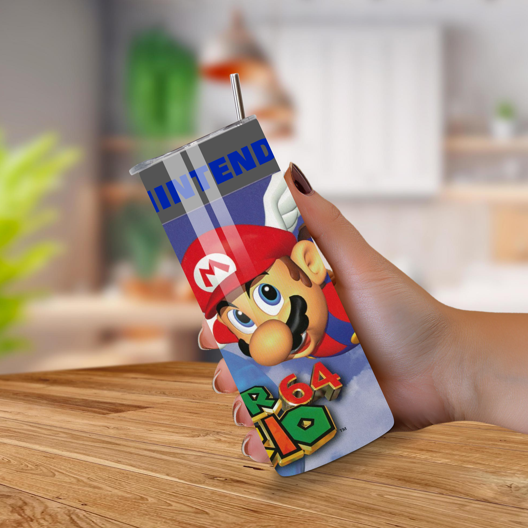 Hand holding a  Nintendo 64 super mario 64 on a wooden surface