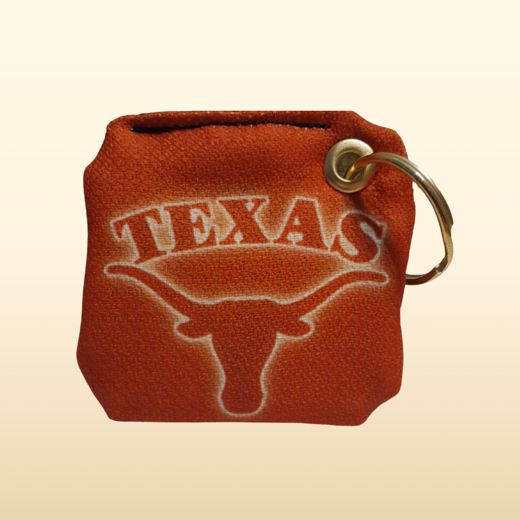 Keychain pouch with 'Texas' and longhorn logo on a beige background