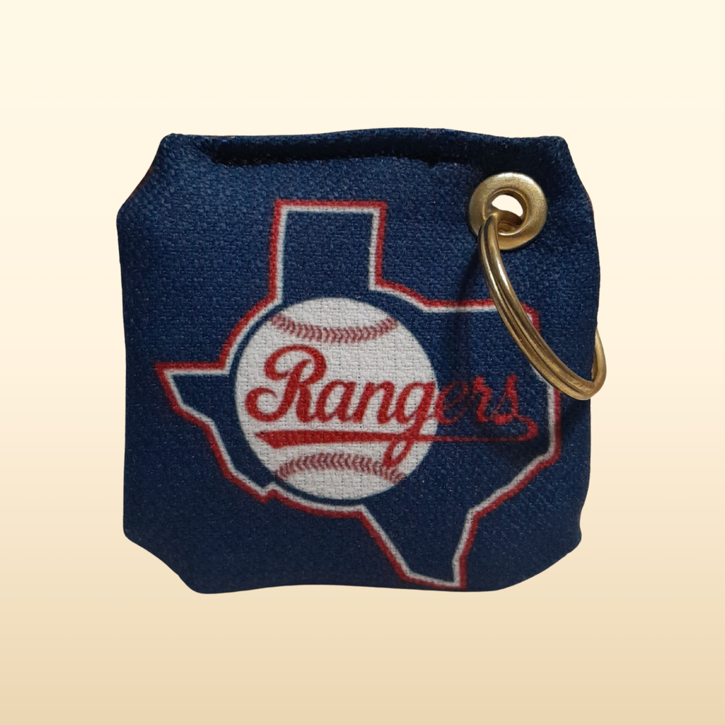 Navy blue keychain pouch with 'Rangers' logo and gold ring on a beige background