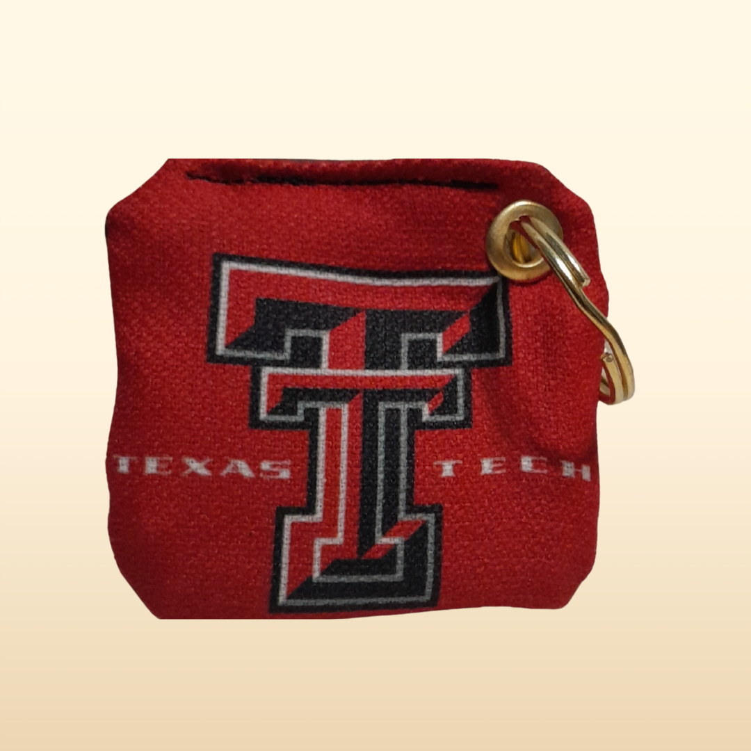 Red keychain with Texas Tech logo on a beige background