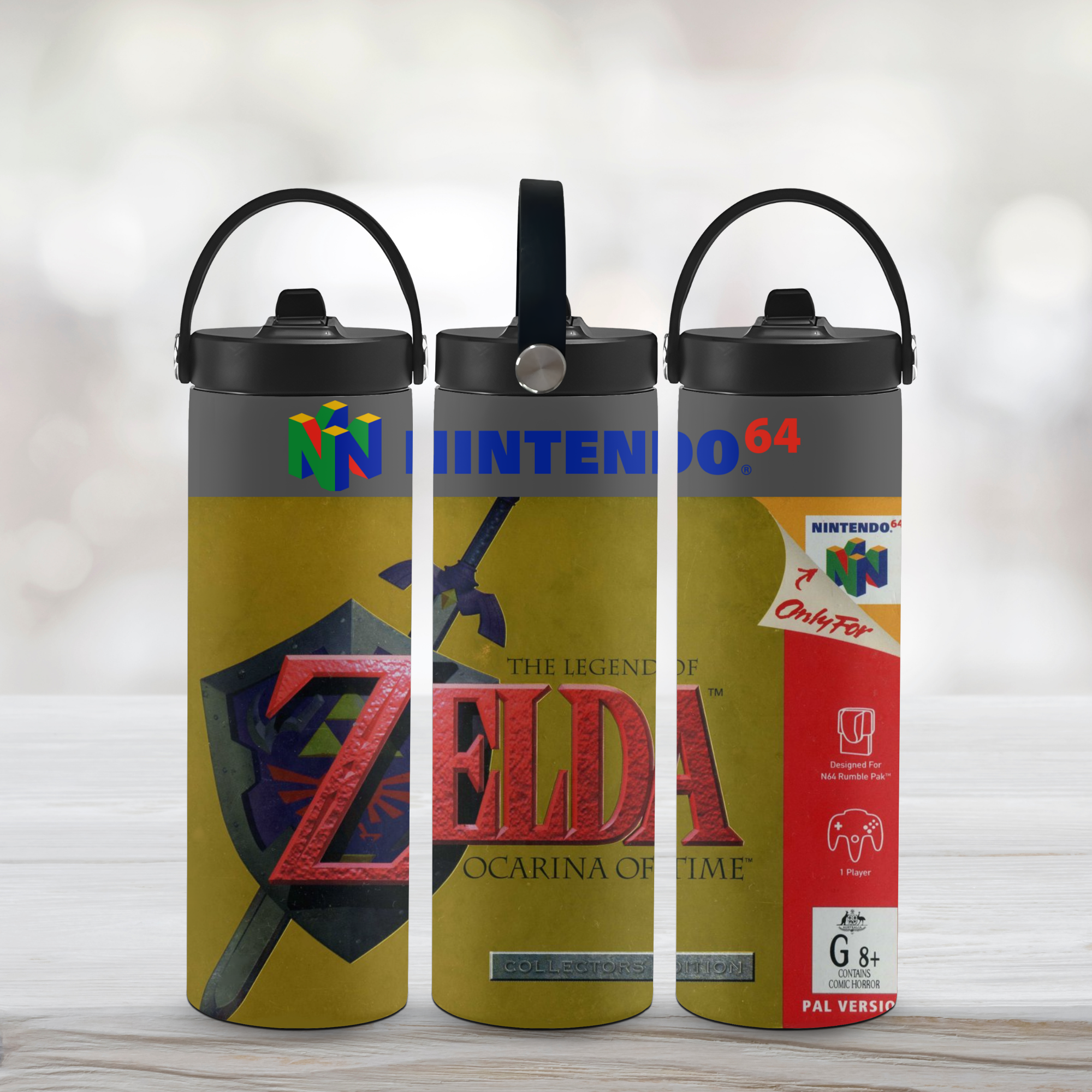 Three tumbler water bottles with 'The Legend of Zelda' design on a light wooden surface.