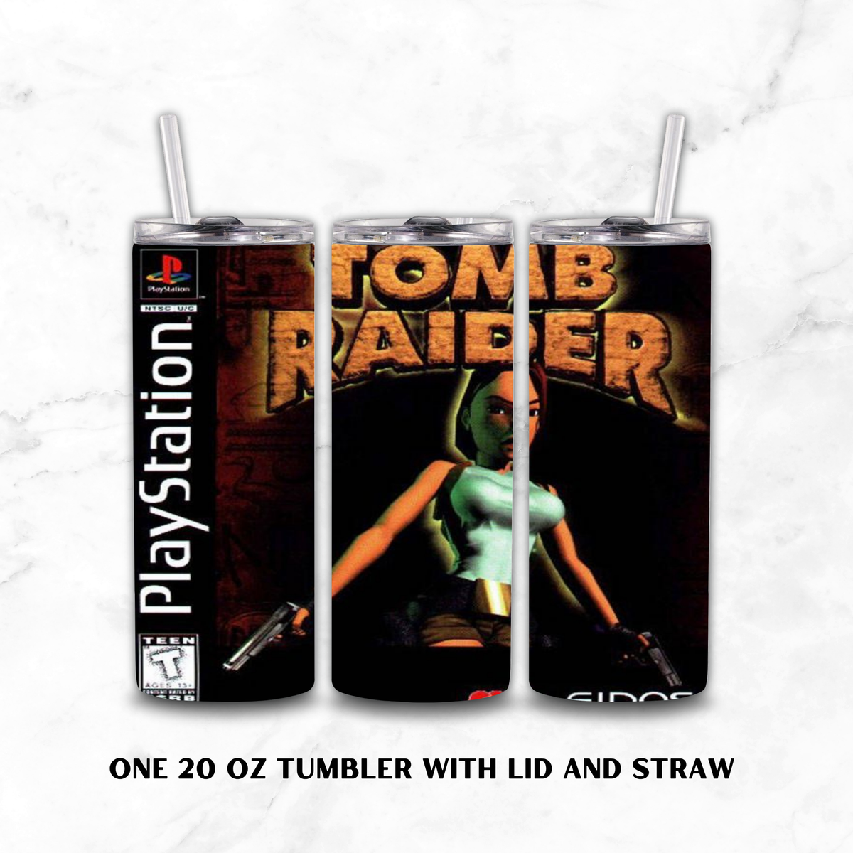 Three views of a 20 oz tumbler with lid and straw, printed with a Tomb Raider video game cover design, shown on a white marble background. The design includes PlayStation branding and the text 'ONE 20 OZ TUMBLER WITH LID AND STRAW' below.