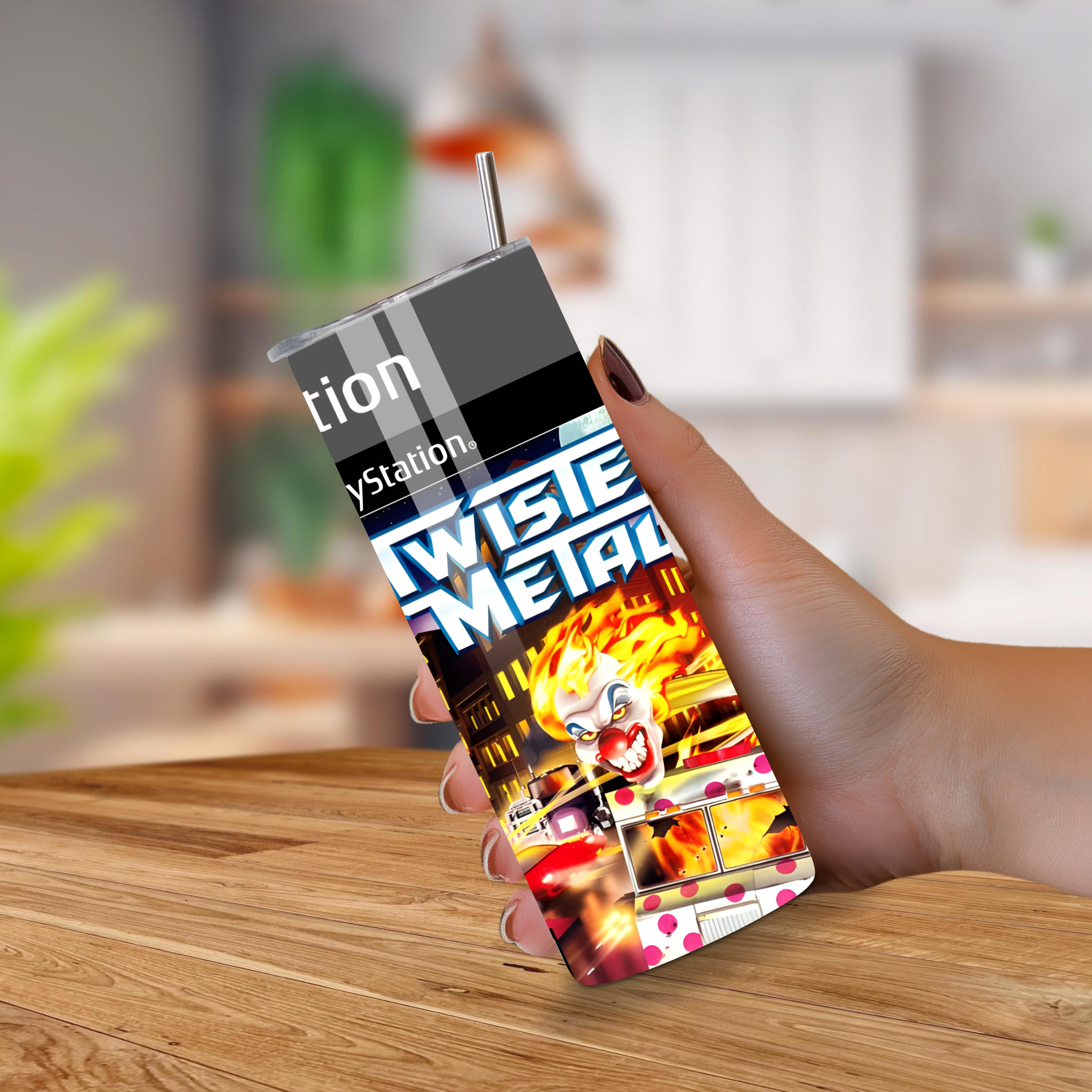 Hand holding a 20oz tumbler with a 'Twist of Metal' design on a wooden surface