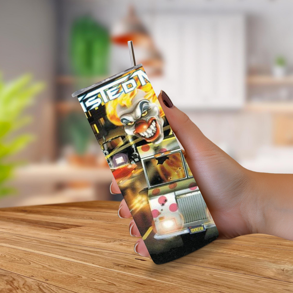 A hand holding a slim 20oz tumbler with a straw, featuring a highly detailed graphic print of a clown and Twisted Metal, set against a blurred indoor background.